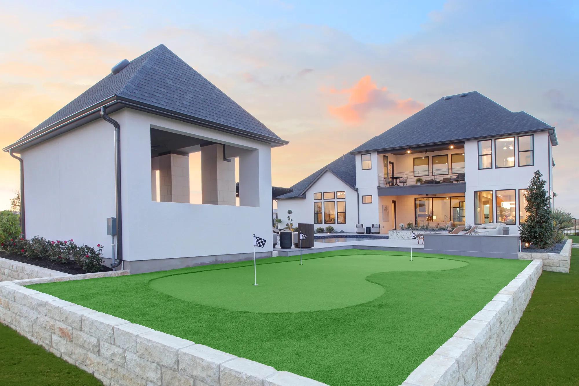 Custom home backyard with golf putting green 