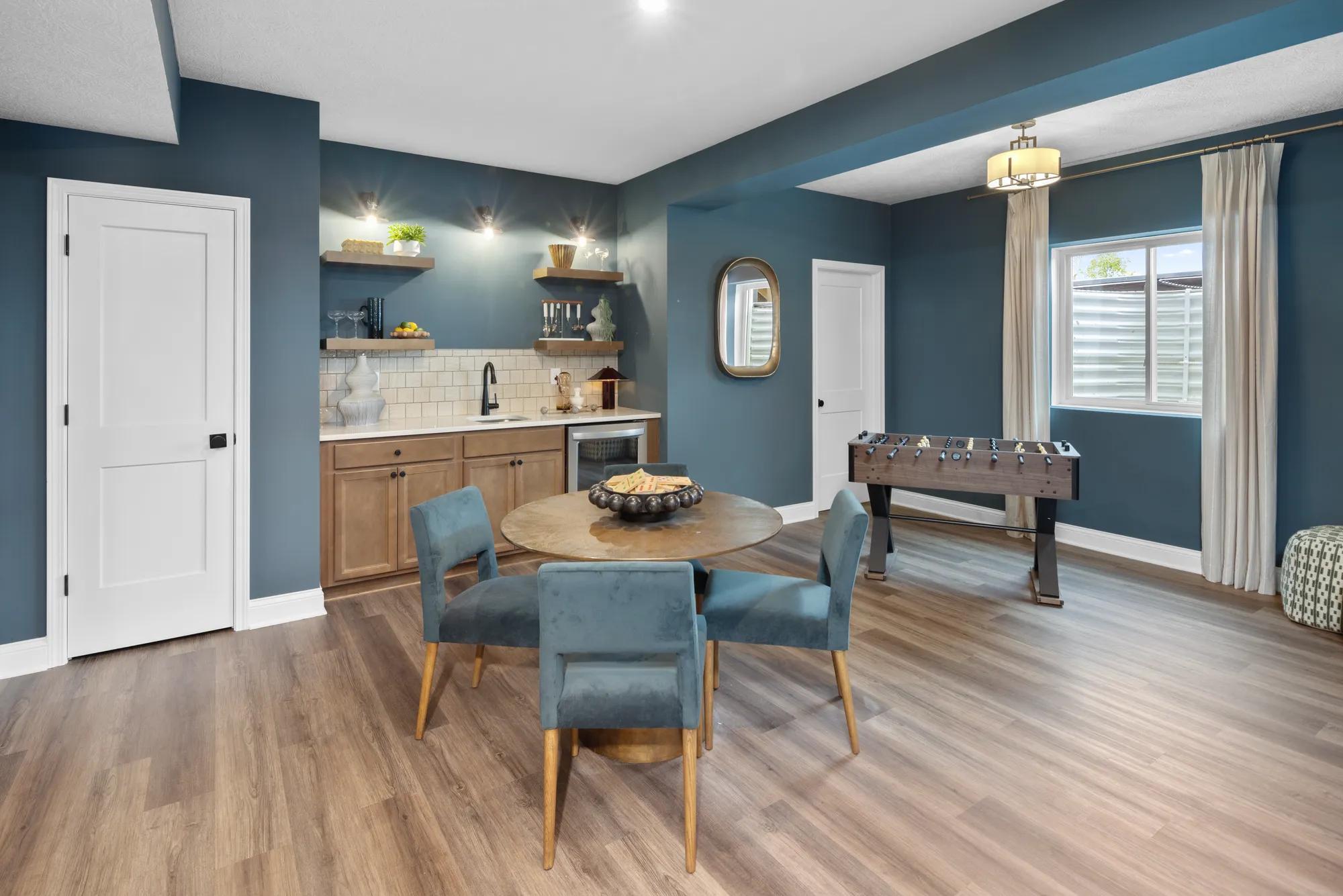 Custom home finished basement with wet bar and hardwood floors