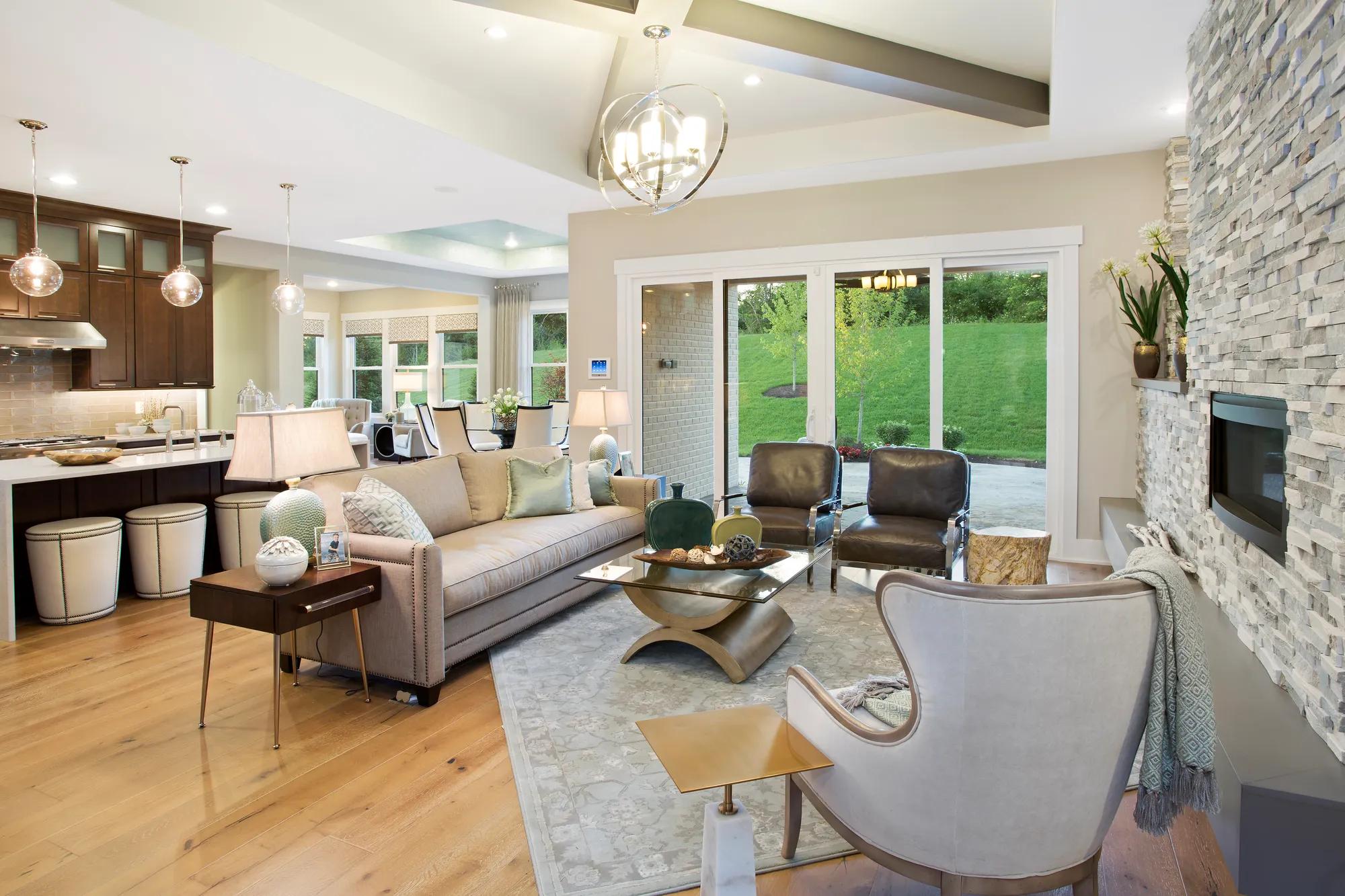 Famiy Room with chandelier and light wood floor.