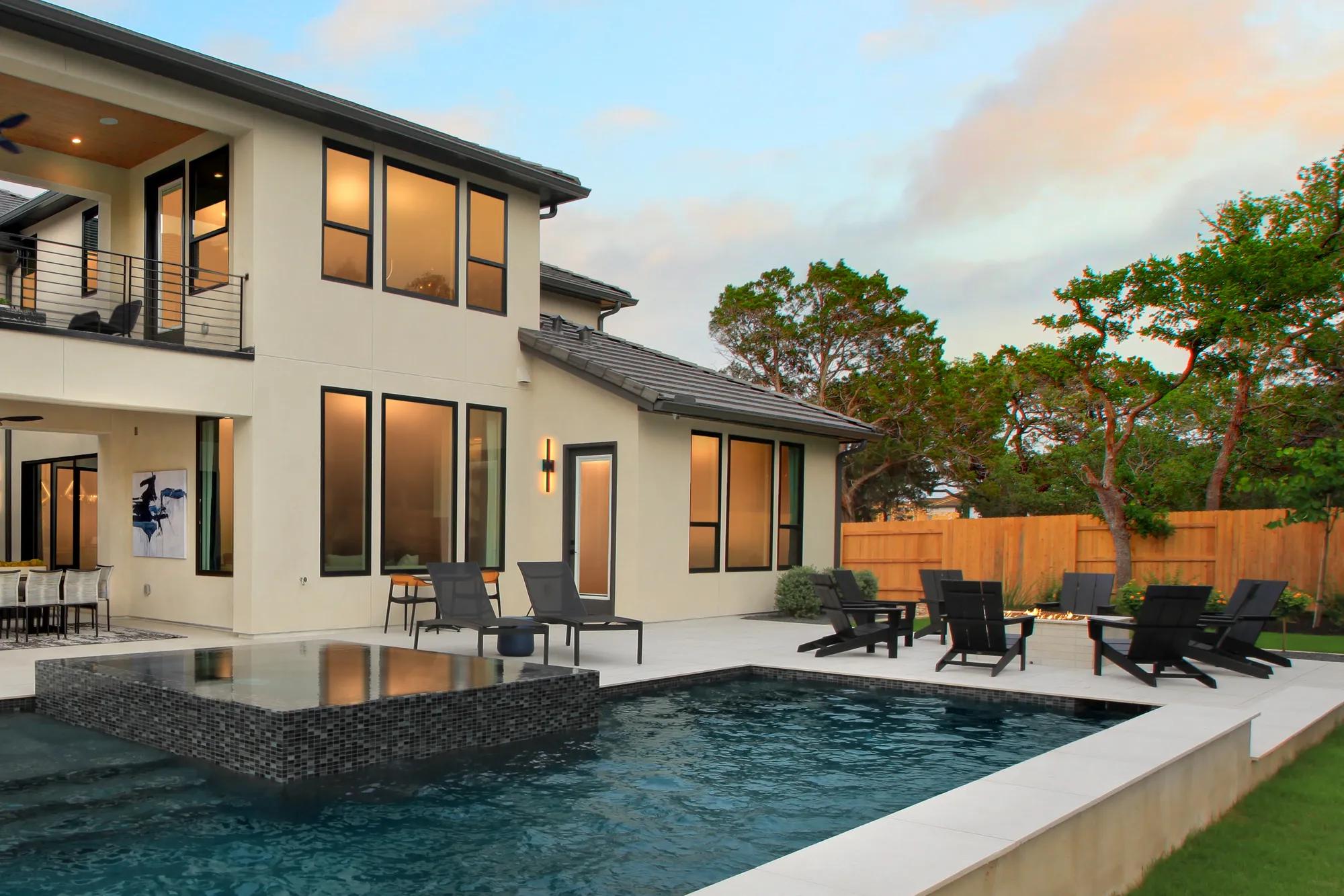 new Drees home outdoor living area with firepit and pool