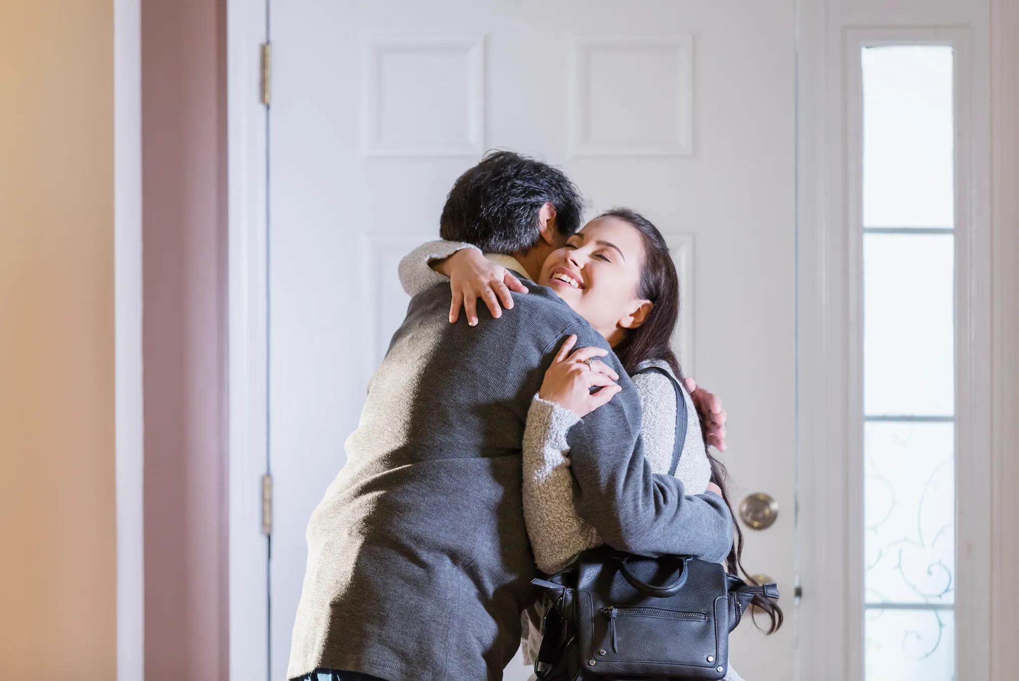 Family hugging in home