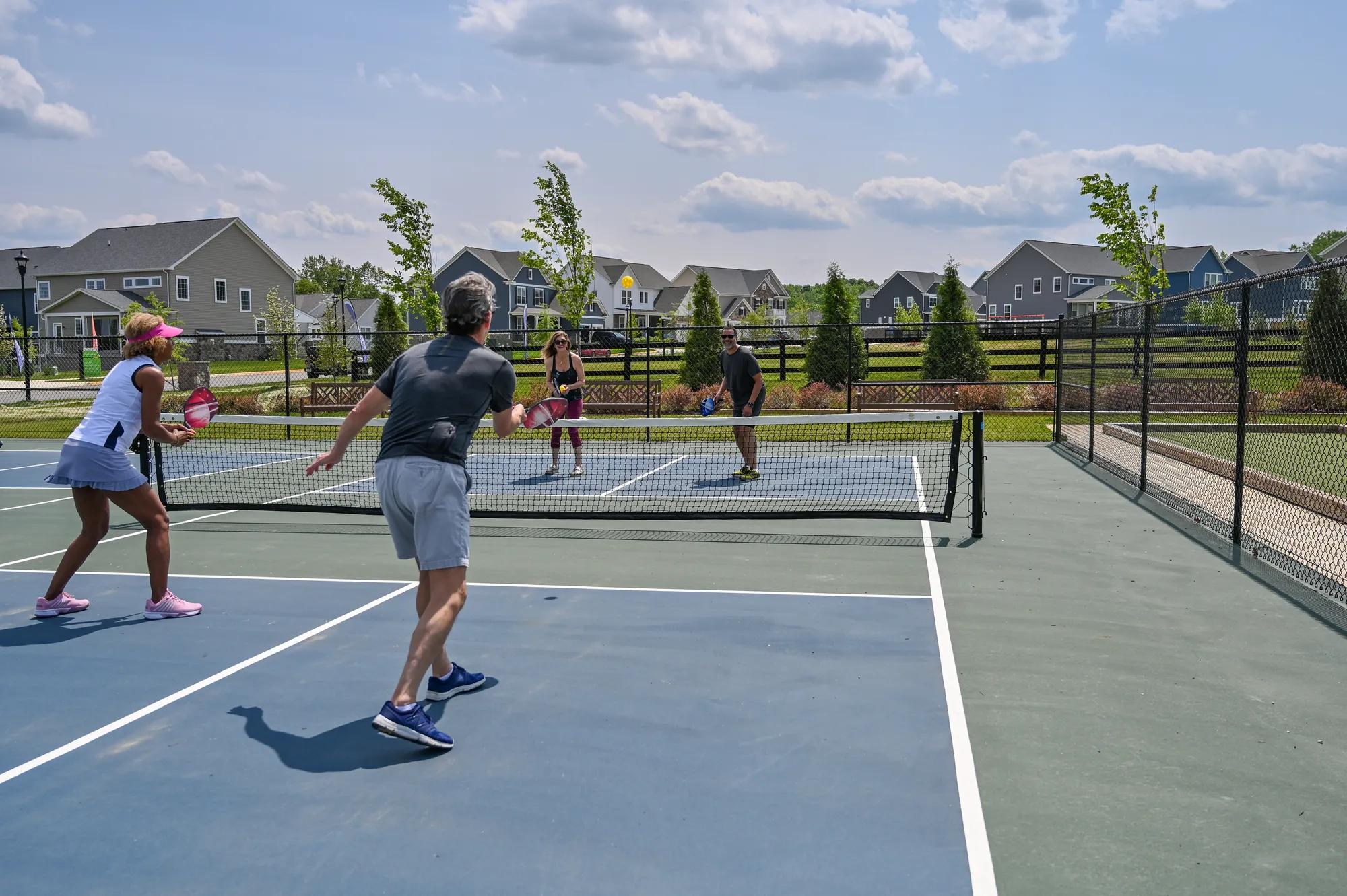 adults playing a pickleball doubles match