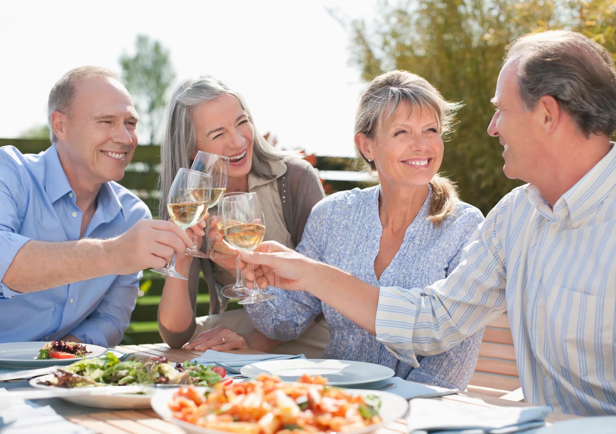 Couples enjoying a meal and wine