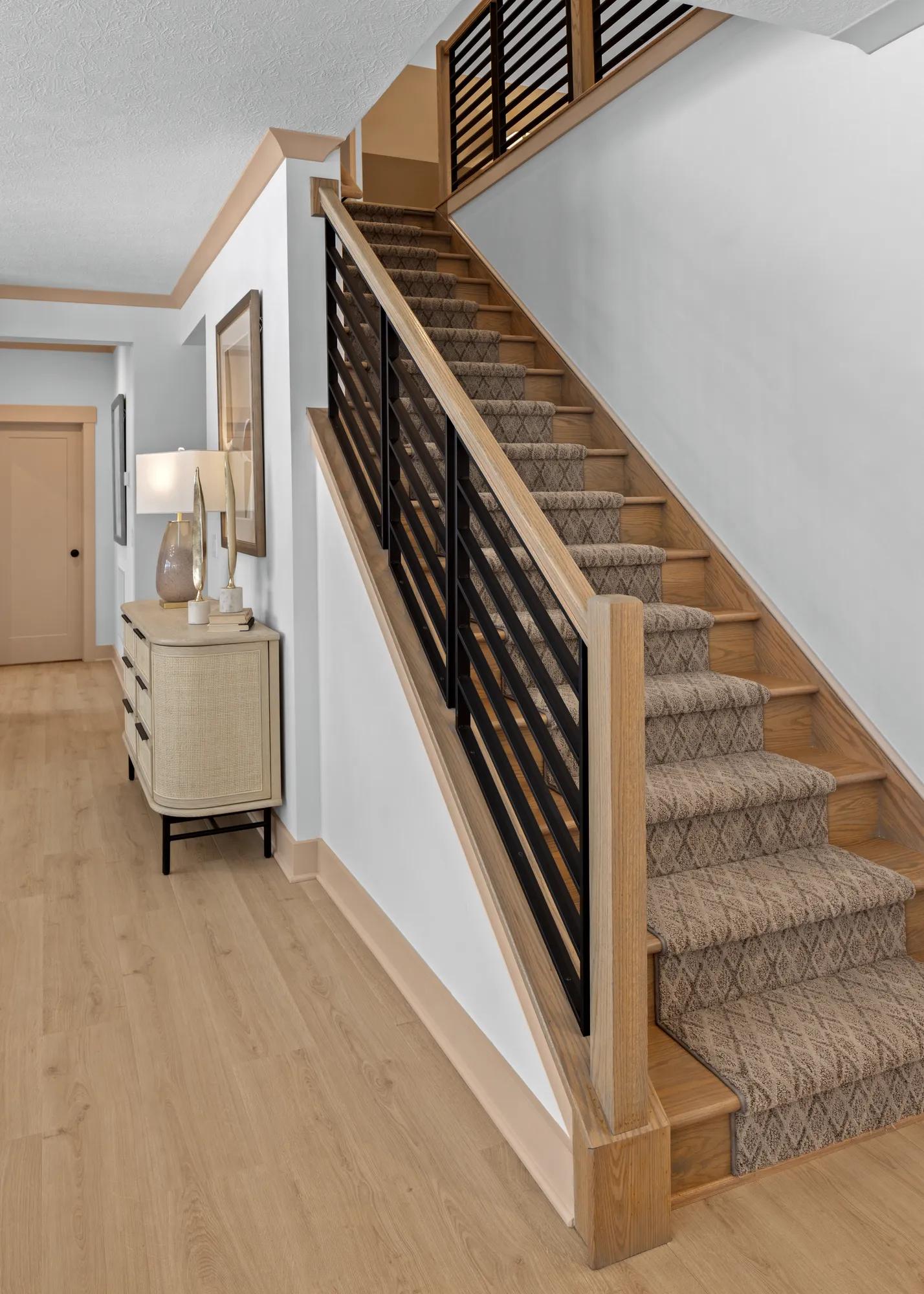 custom home staircase with stained railing