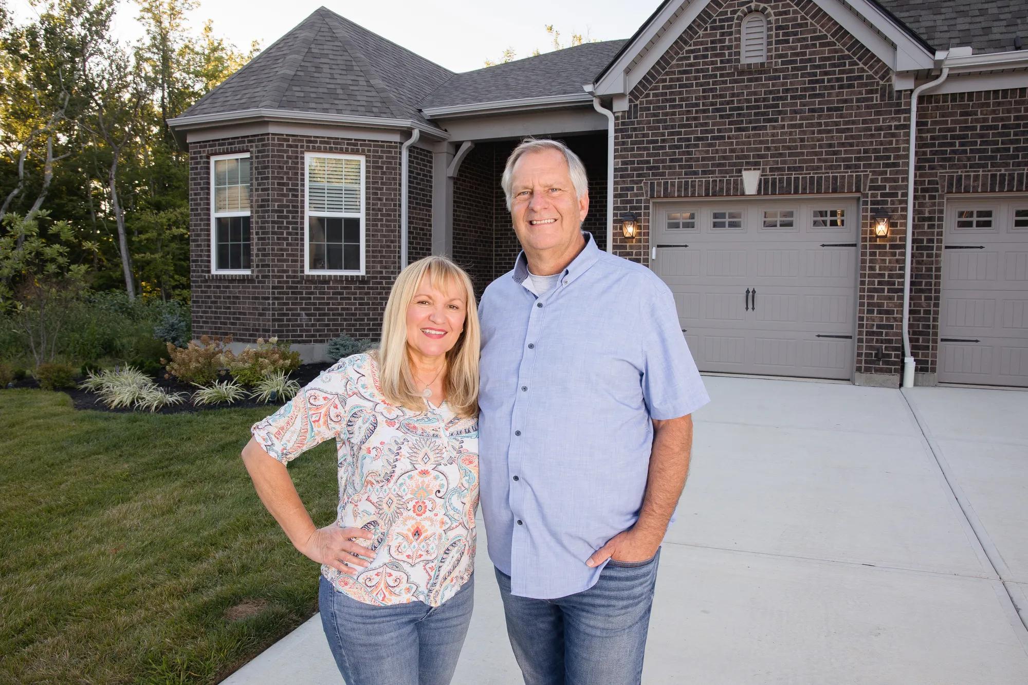 New homeowners outside of their Drees home