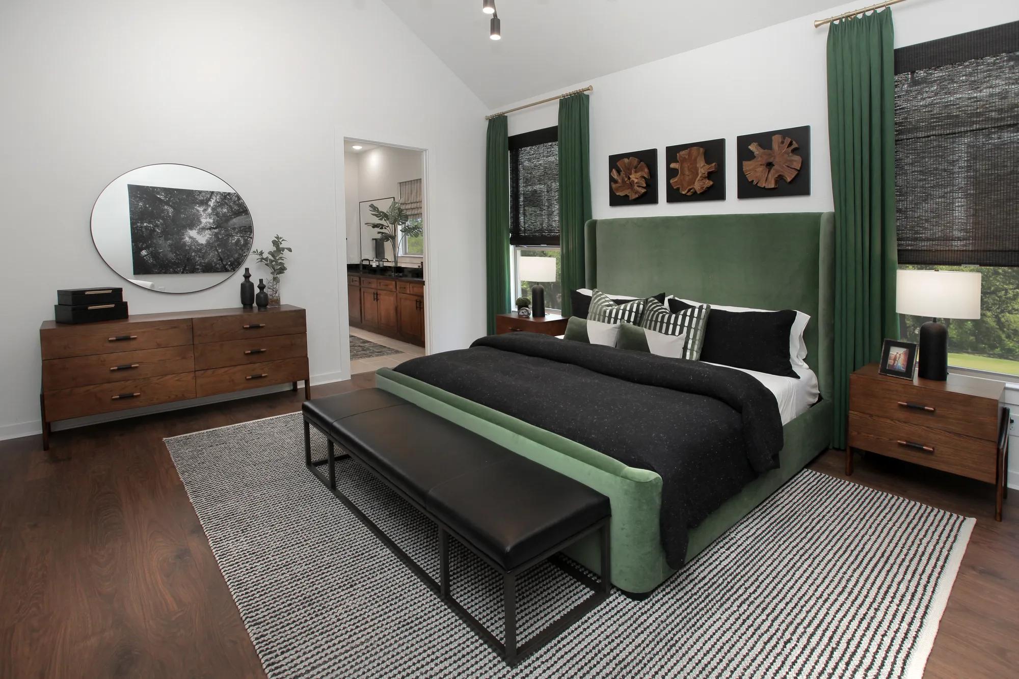 custom home primary bedroom with vaulted ceiling