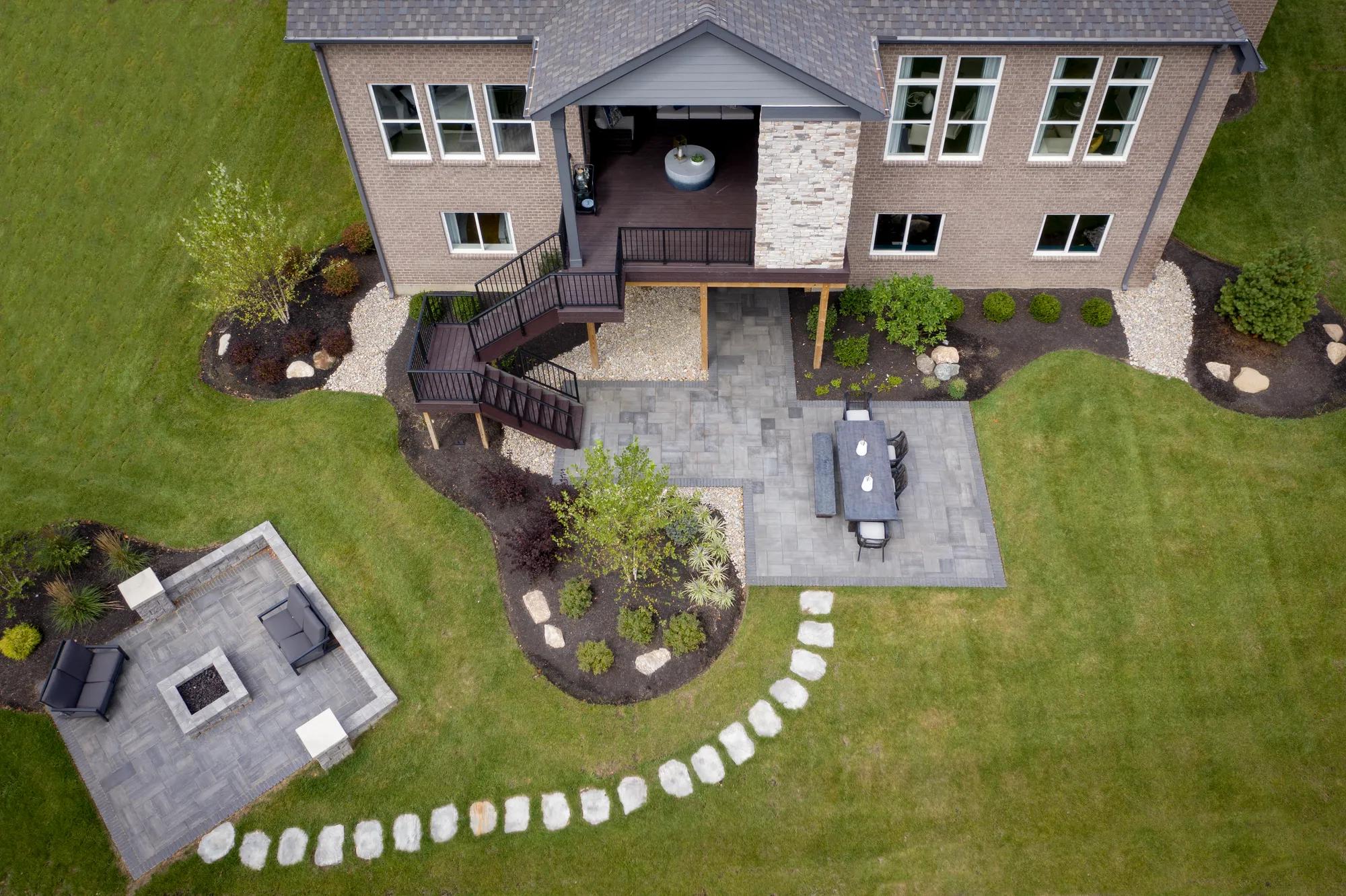 aerial view of home rear exterior and outdoor living area