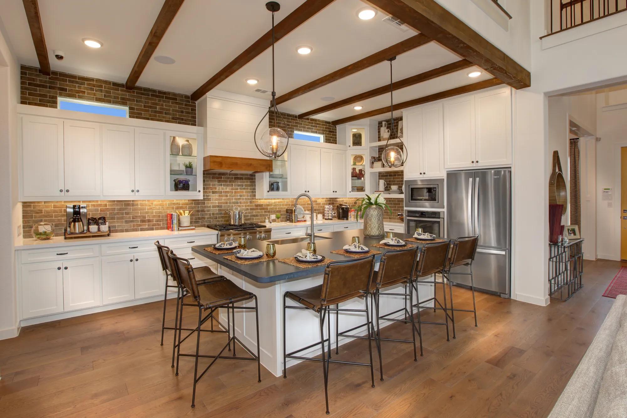 Kitchen with beam ceiling and large island