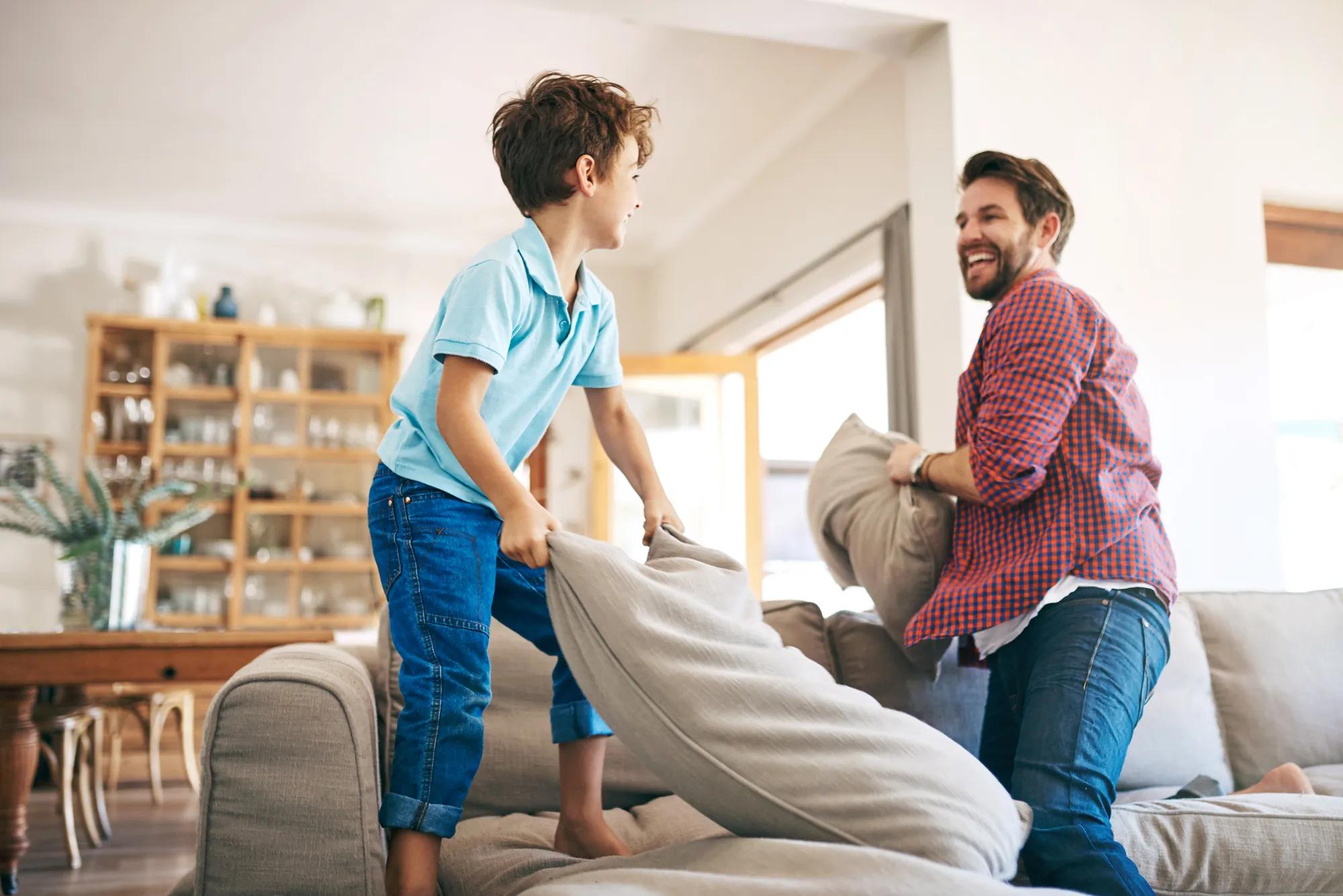 Father son playing in new home family room