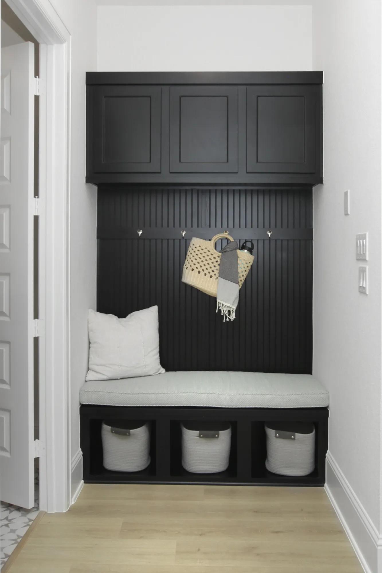 Custom home family foyer mud room with built in bench and black cabinet storage