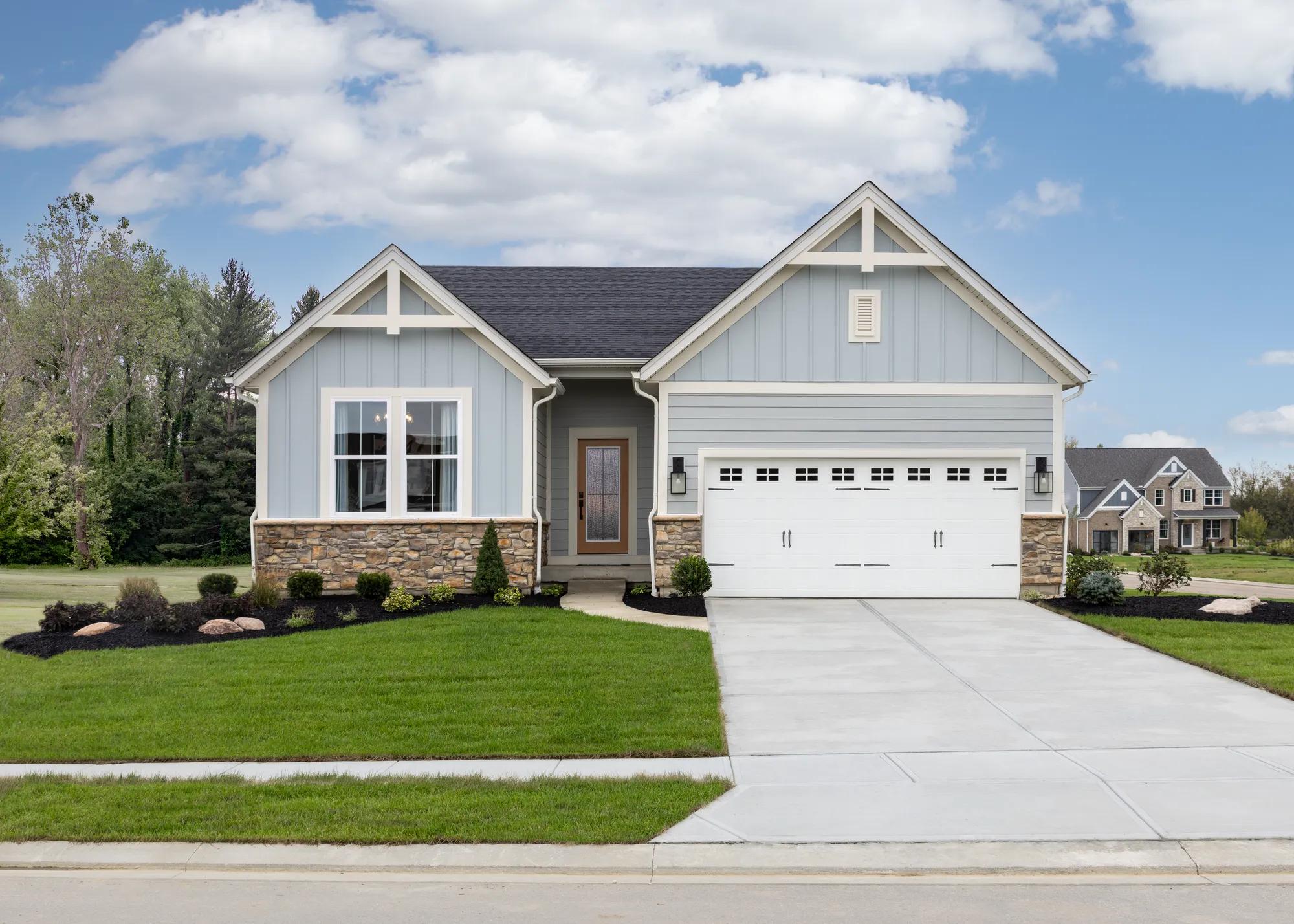 custom home with board and batten and stone exterior