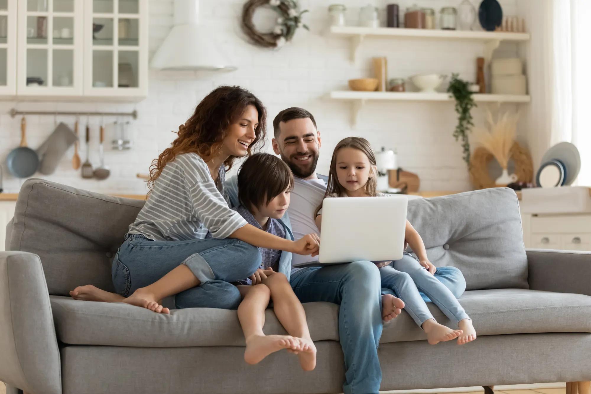 family on laptop in living room
