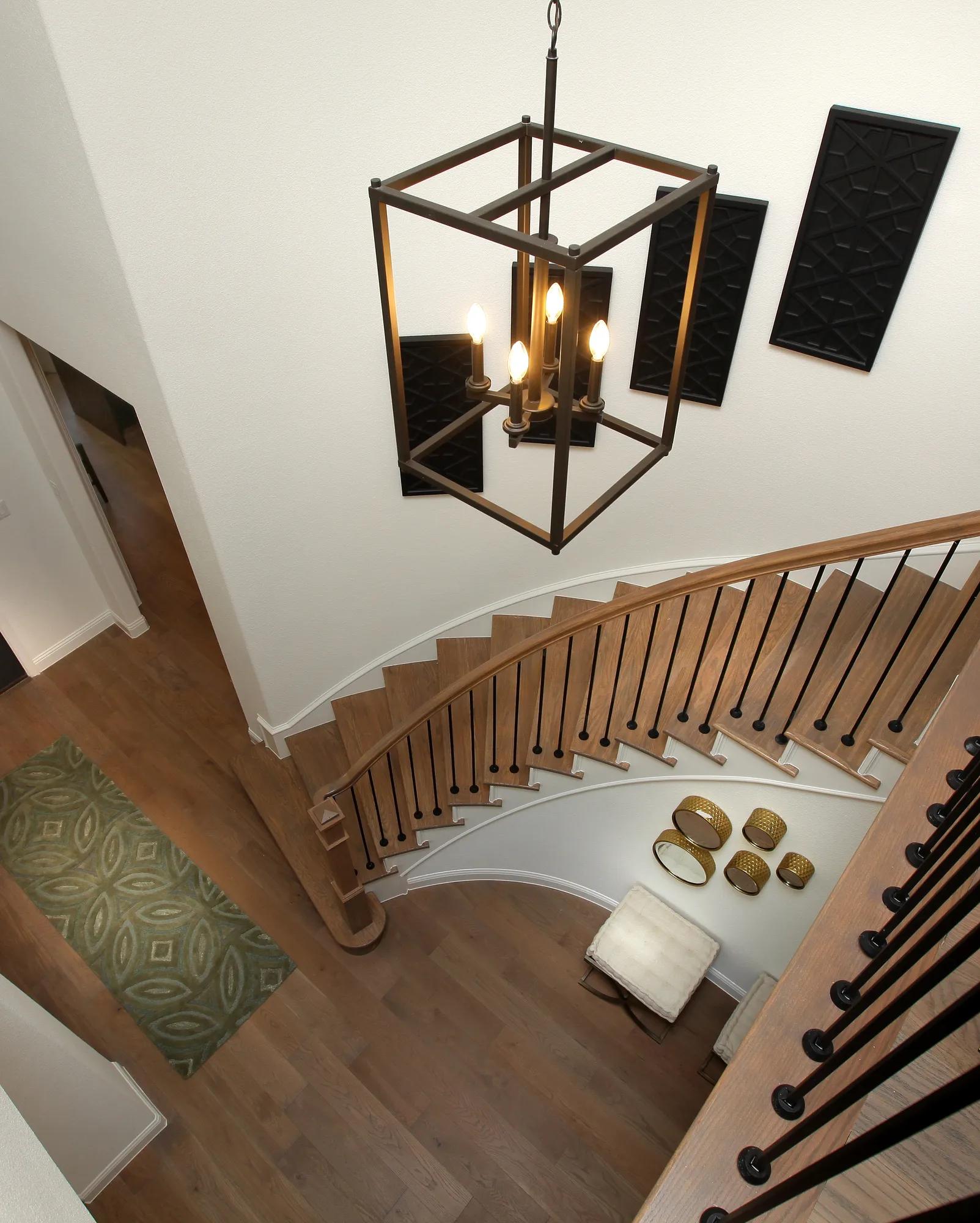 Foyer with modern light fixture and curved staircase