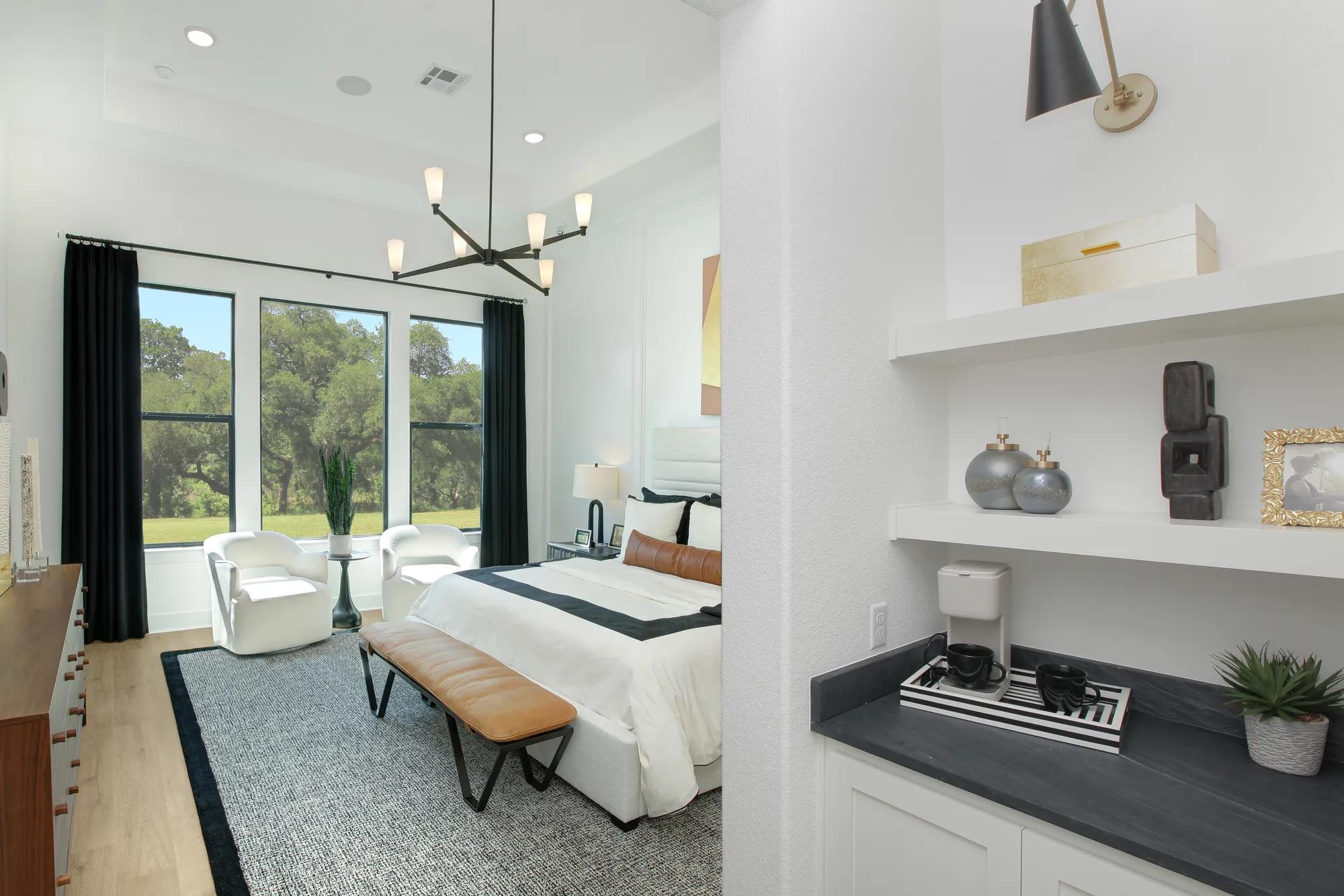 Custom home primary suite with coffee bar with white cabinets and shelves
