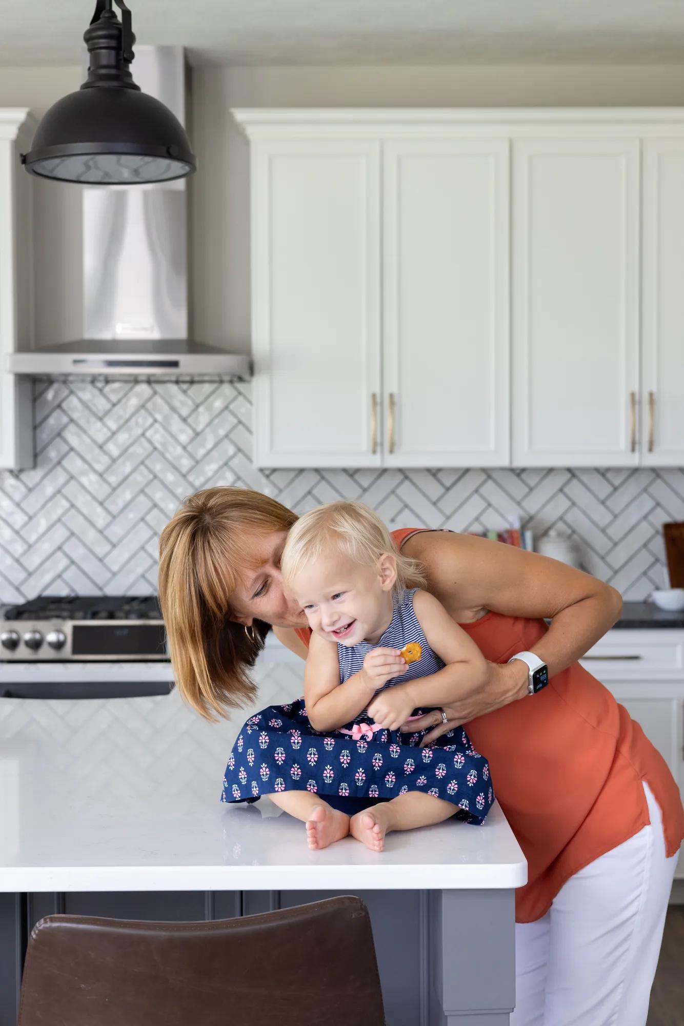 New homeowners gathering in the luxurious and luminous Buchanan kitchen