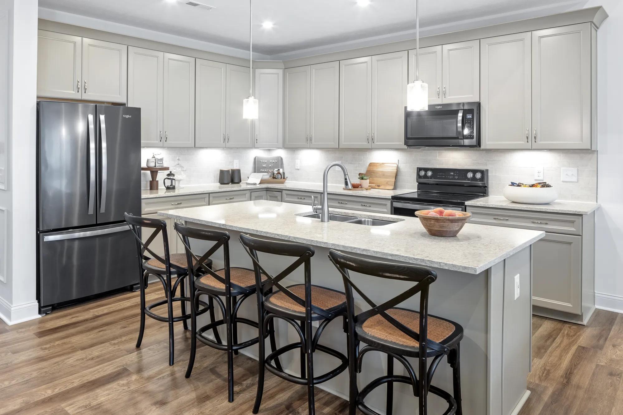 custom kitchen with large island and stainless steel appliances