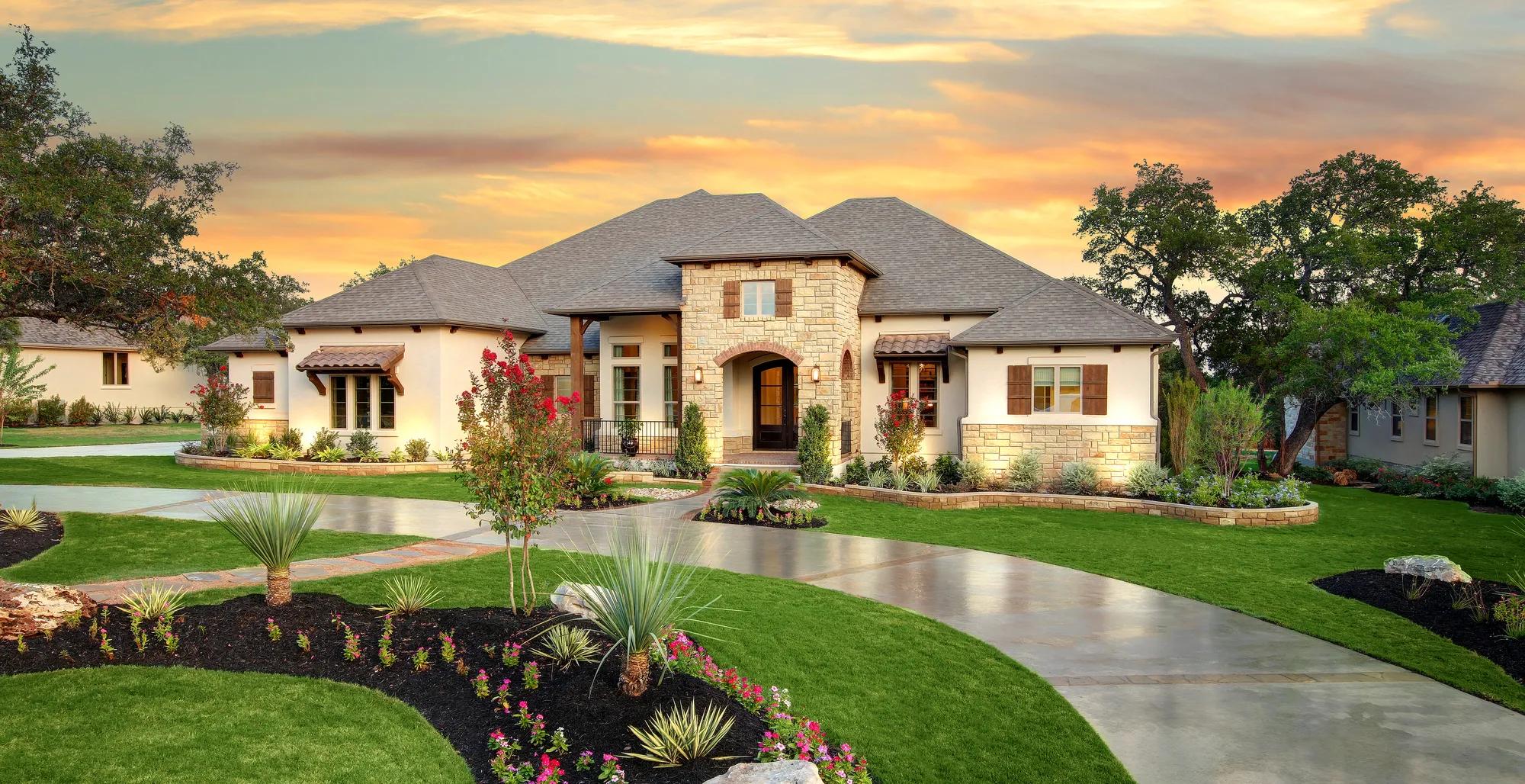 Exterior of a stately home featuring beautiful landscaping