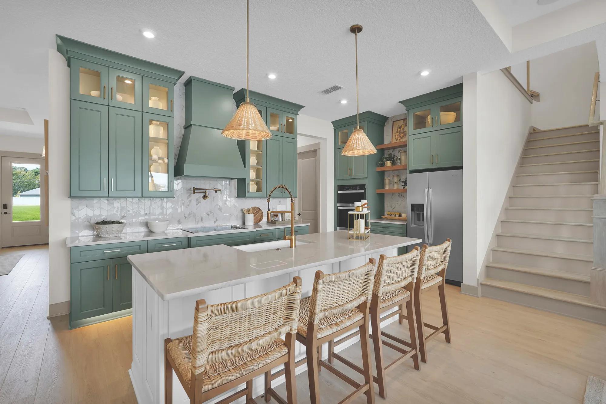 New home kitchen with contrasting island and staircase to second floor