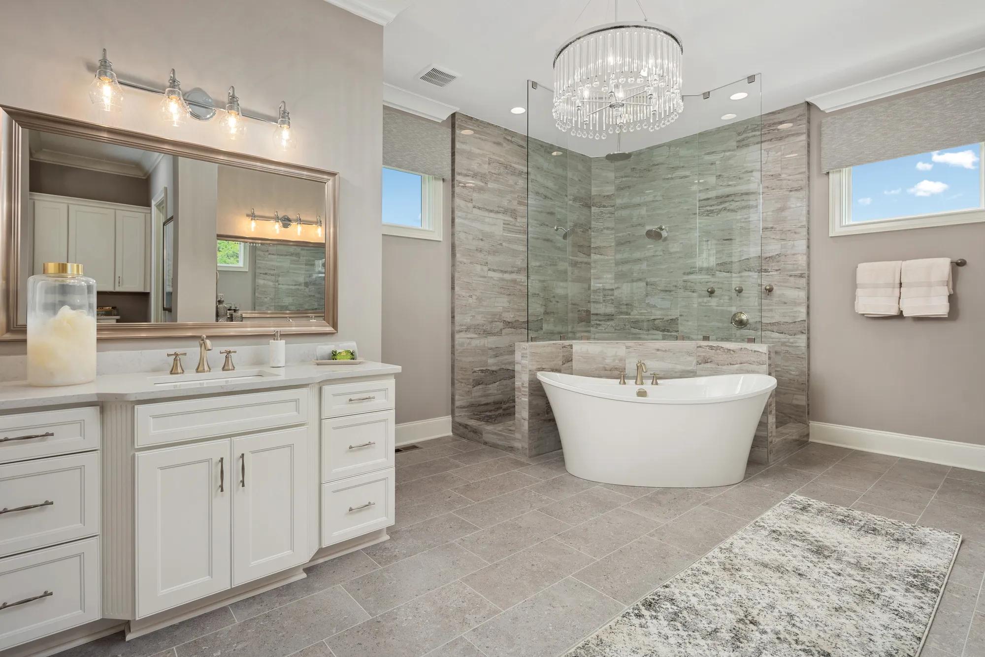 Primary Bath with freestanding tub, white vanity and deluxe shower