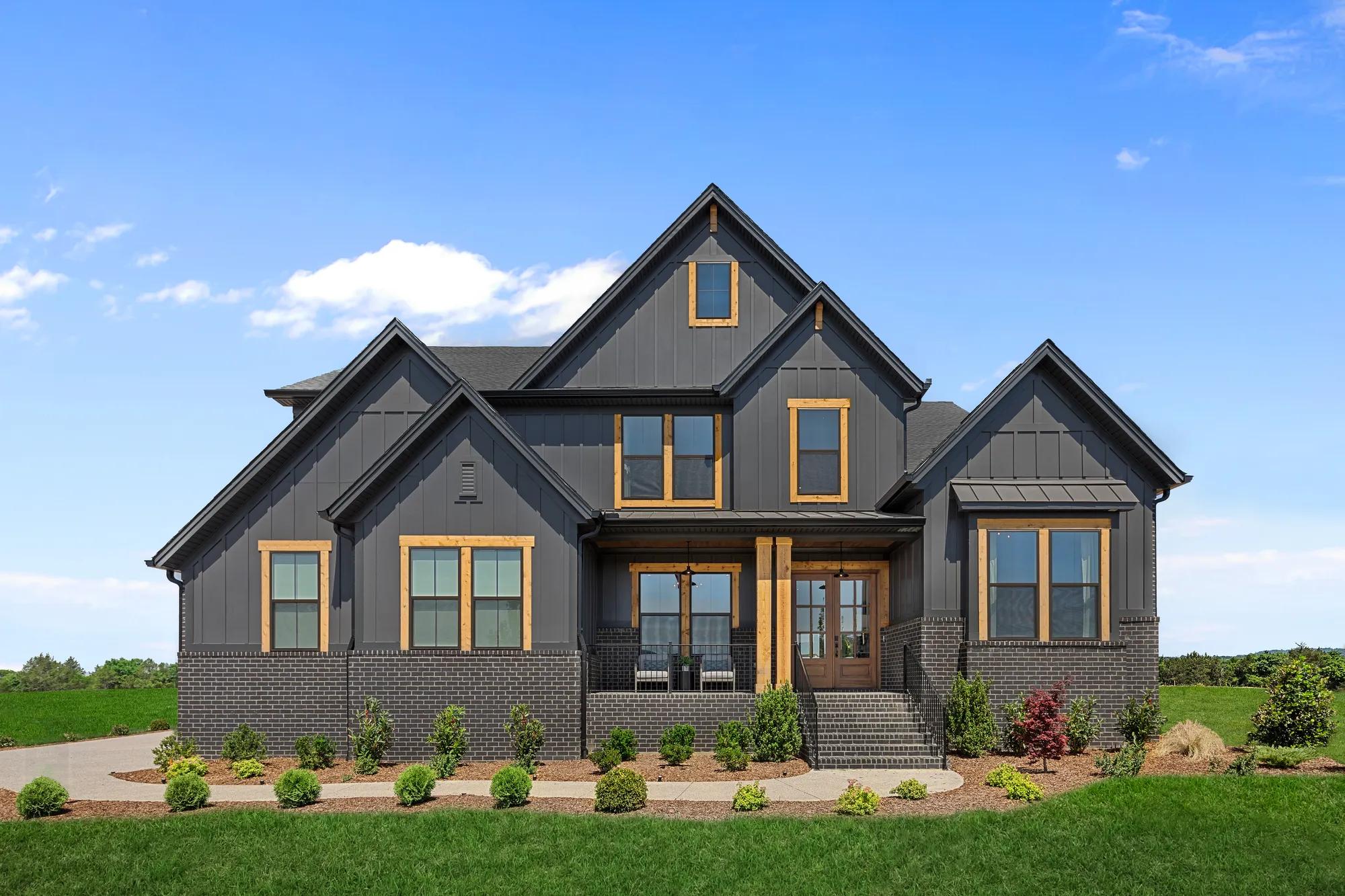 custom home with board and batten and brick exterior