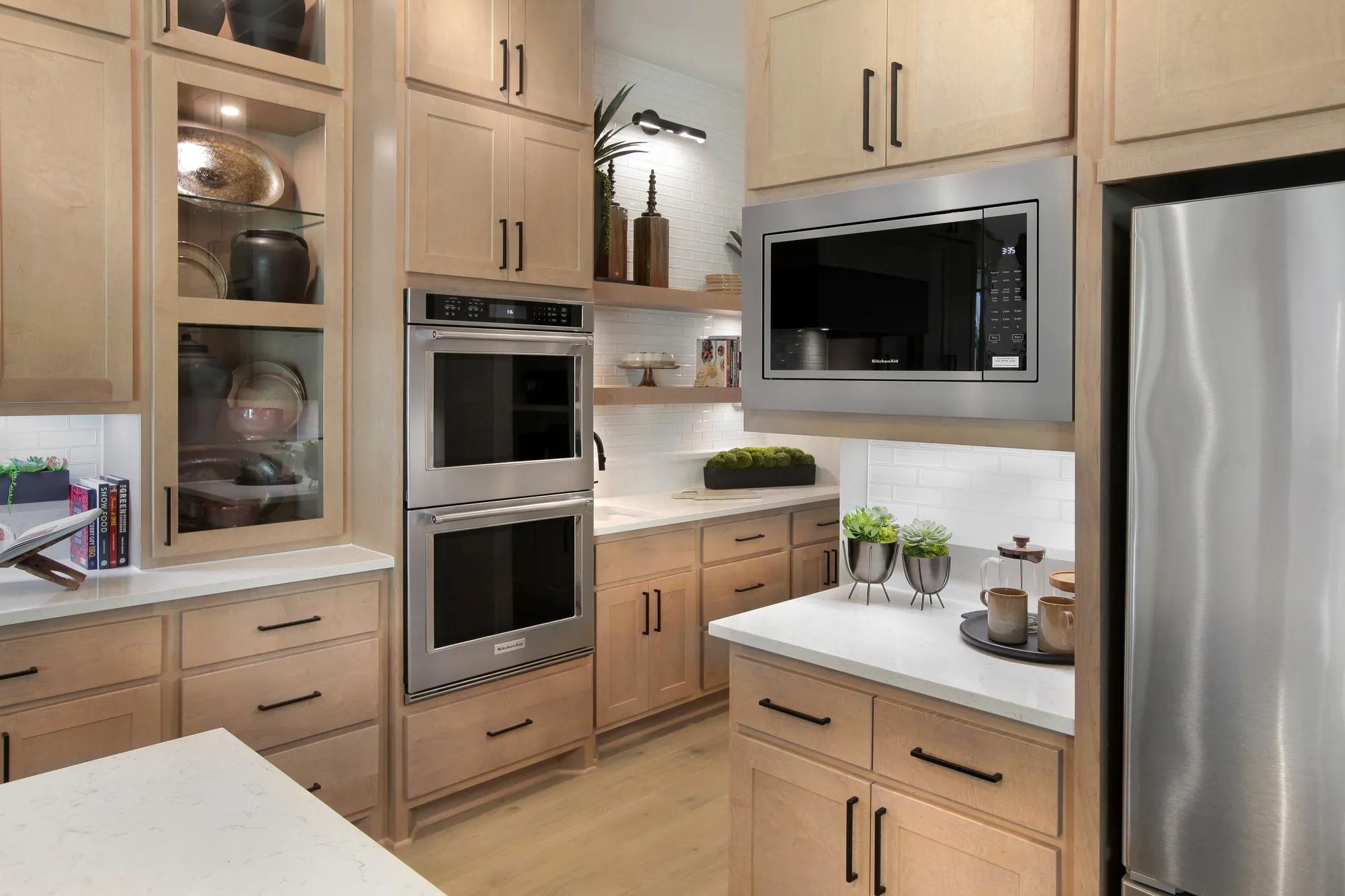 Custom home kitchen with double ovens and stainless steel appliances