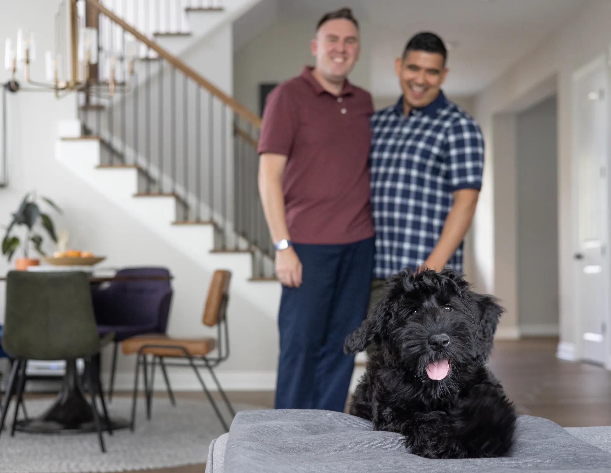 Couple with dog enjoying new home