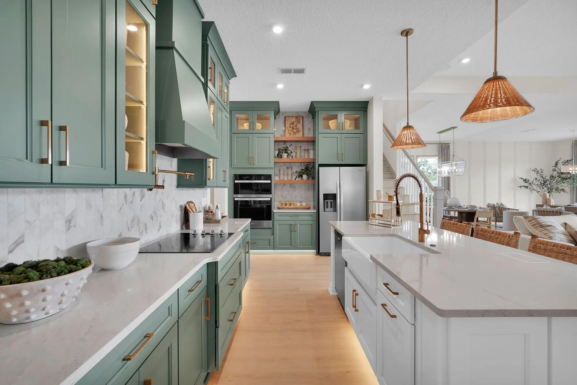 Custom home luxury kitchen with farm sink, pot filler, floating shelves, and modern green cabinets