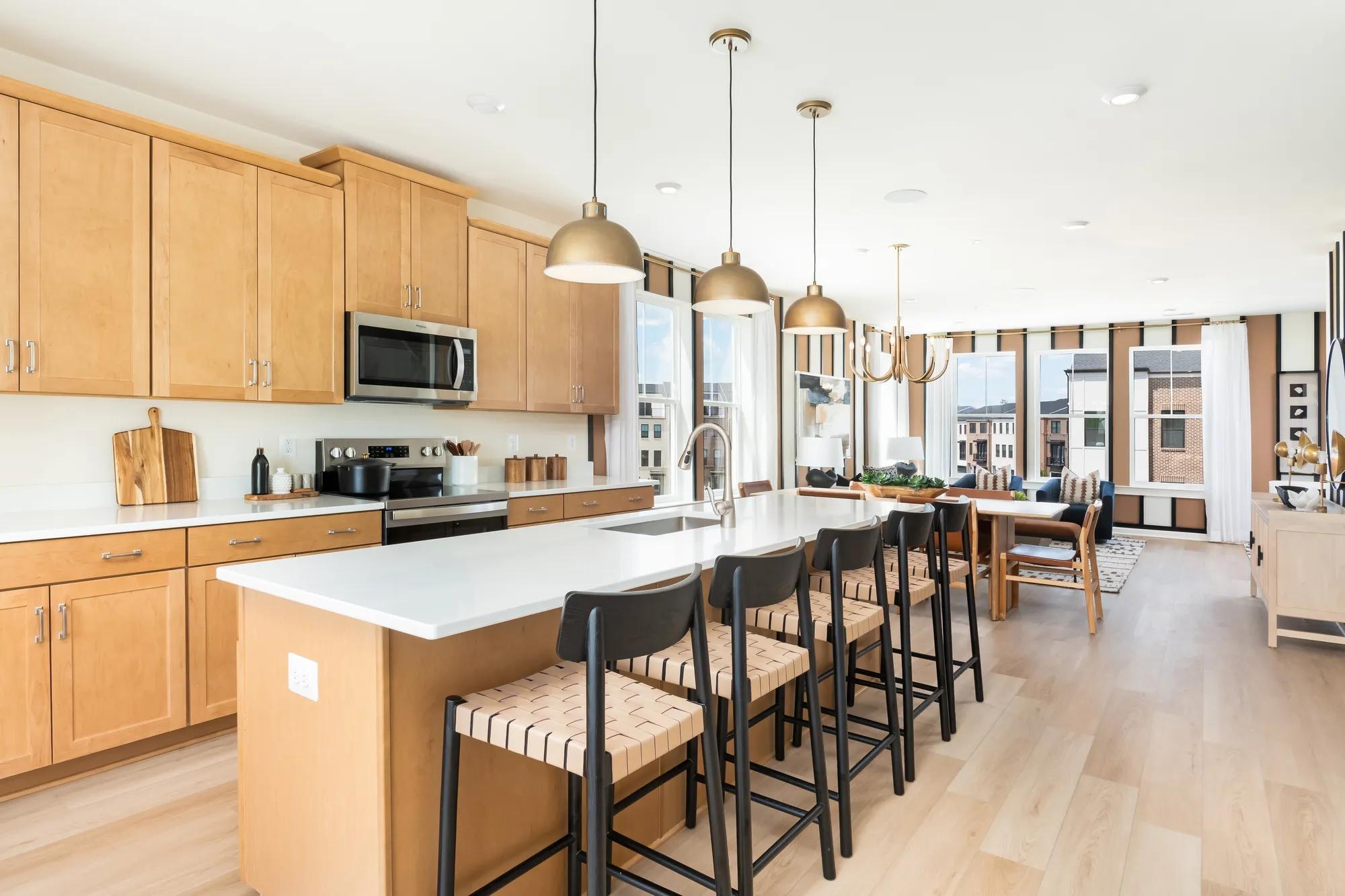 New townhome open floor plan family room, dining, and kitchen with island