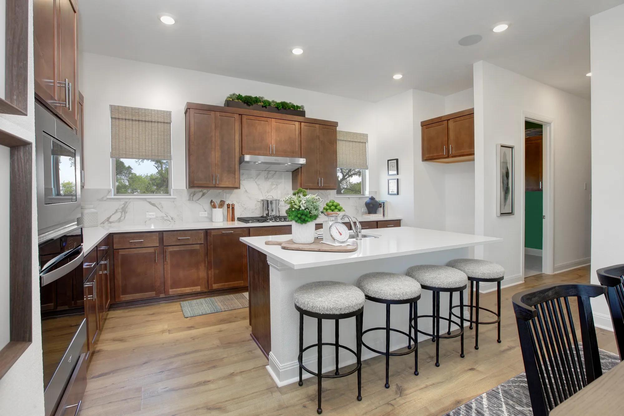 Custom home open floor plan kitchen with island and dark wood cabinets