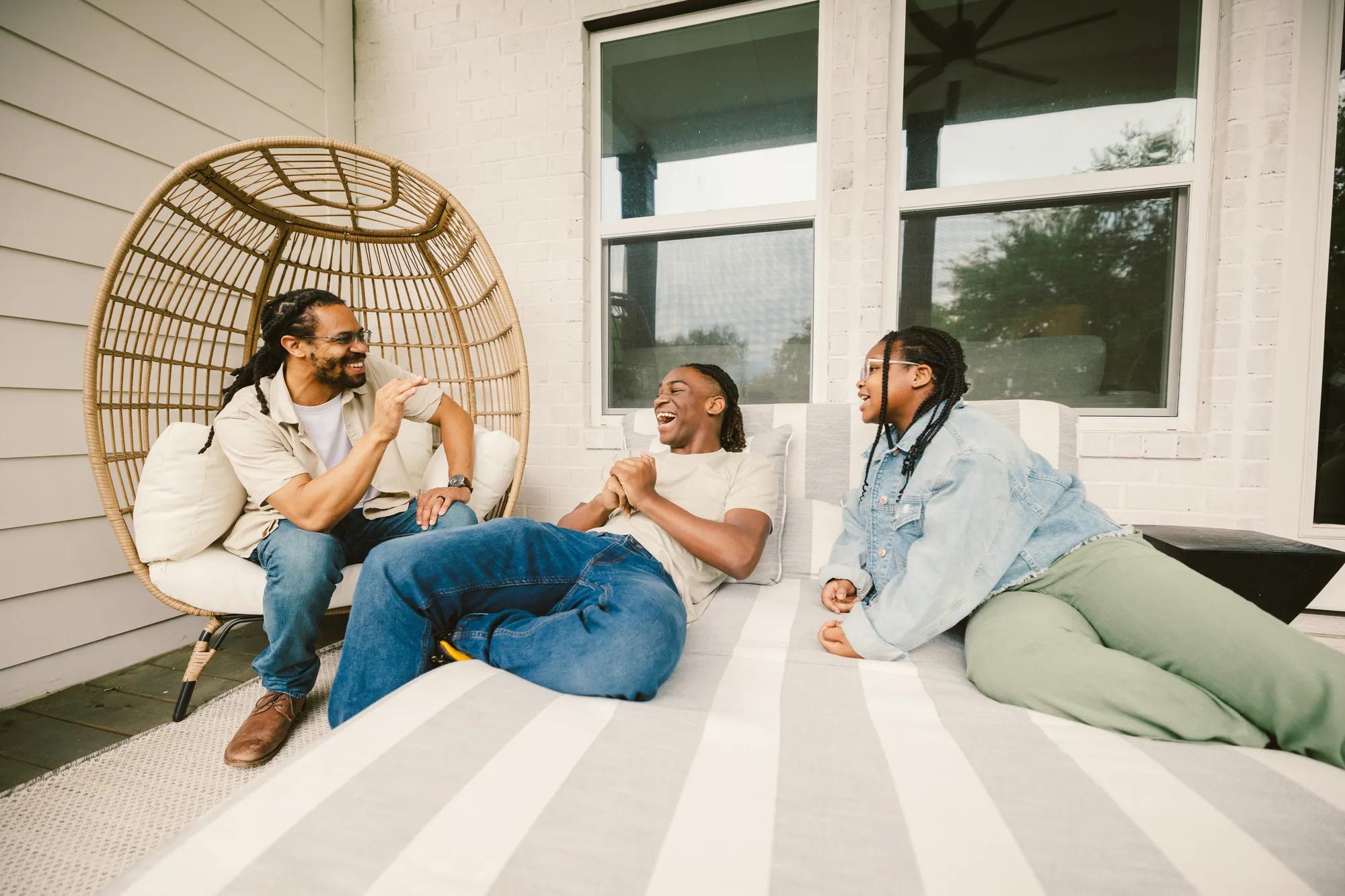 New homeowners enjoying a gorgeous day on their Drees Home front porch