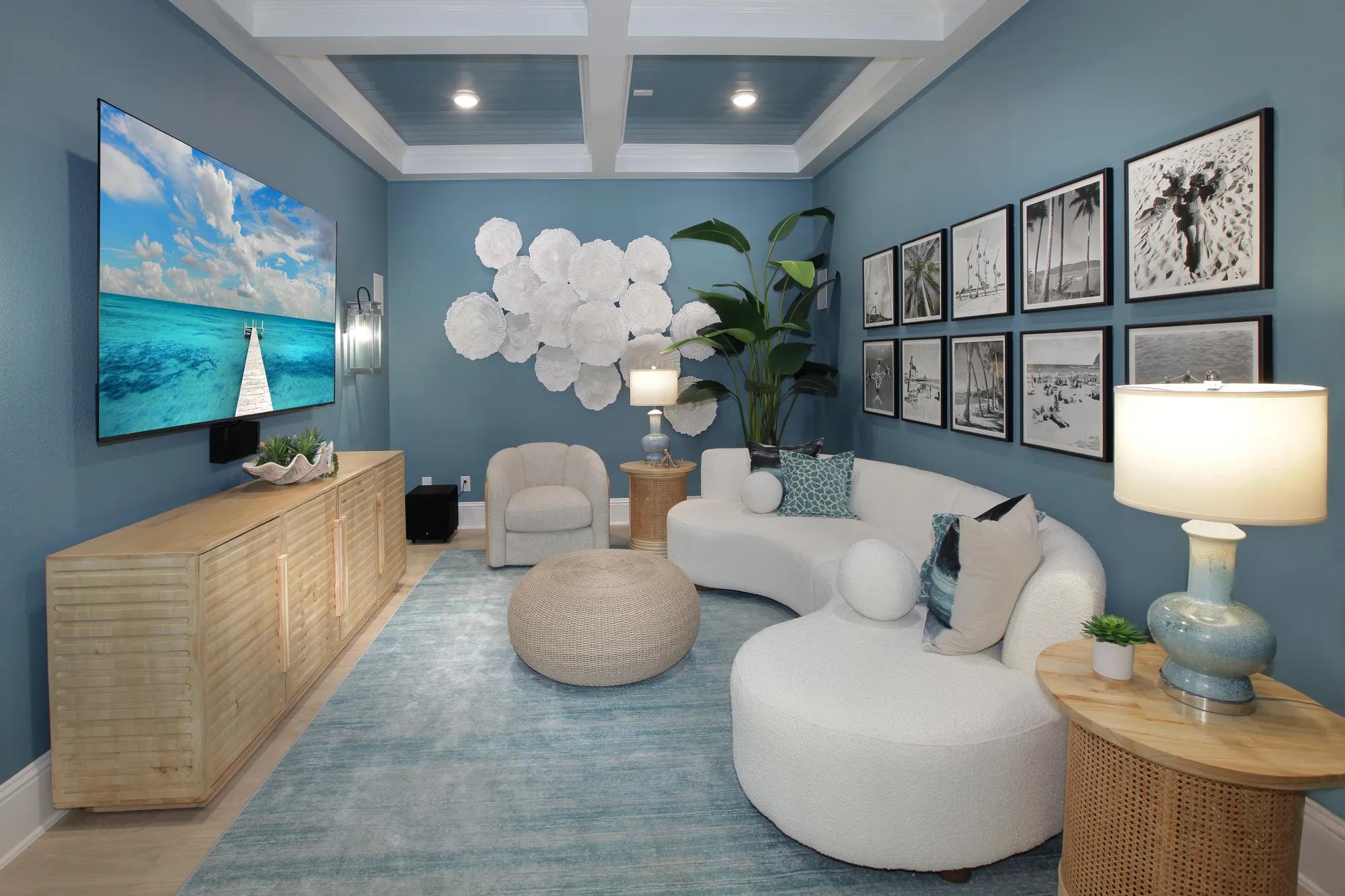 New home media room with painted blue walls and coffered ceiling