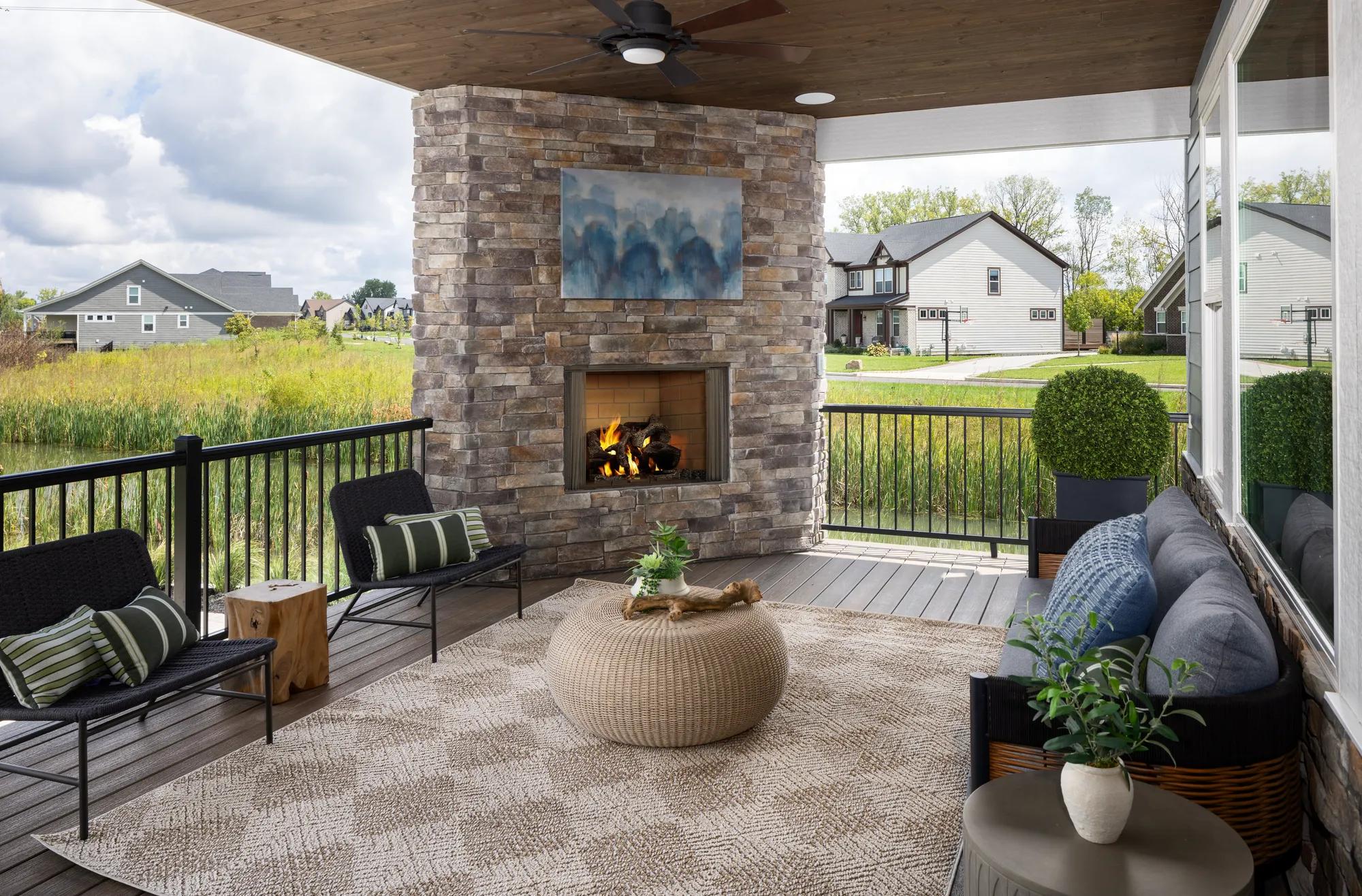 New home back porch with stone fireplace and wood panel ceiling