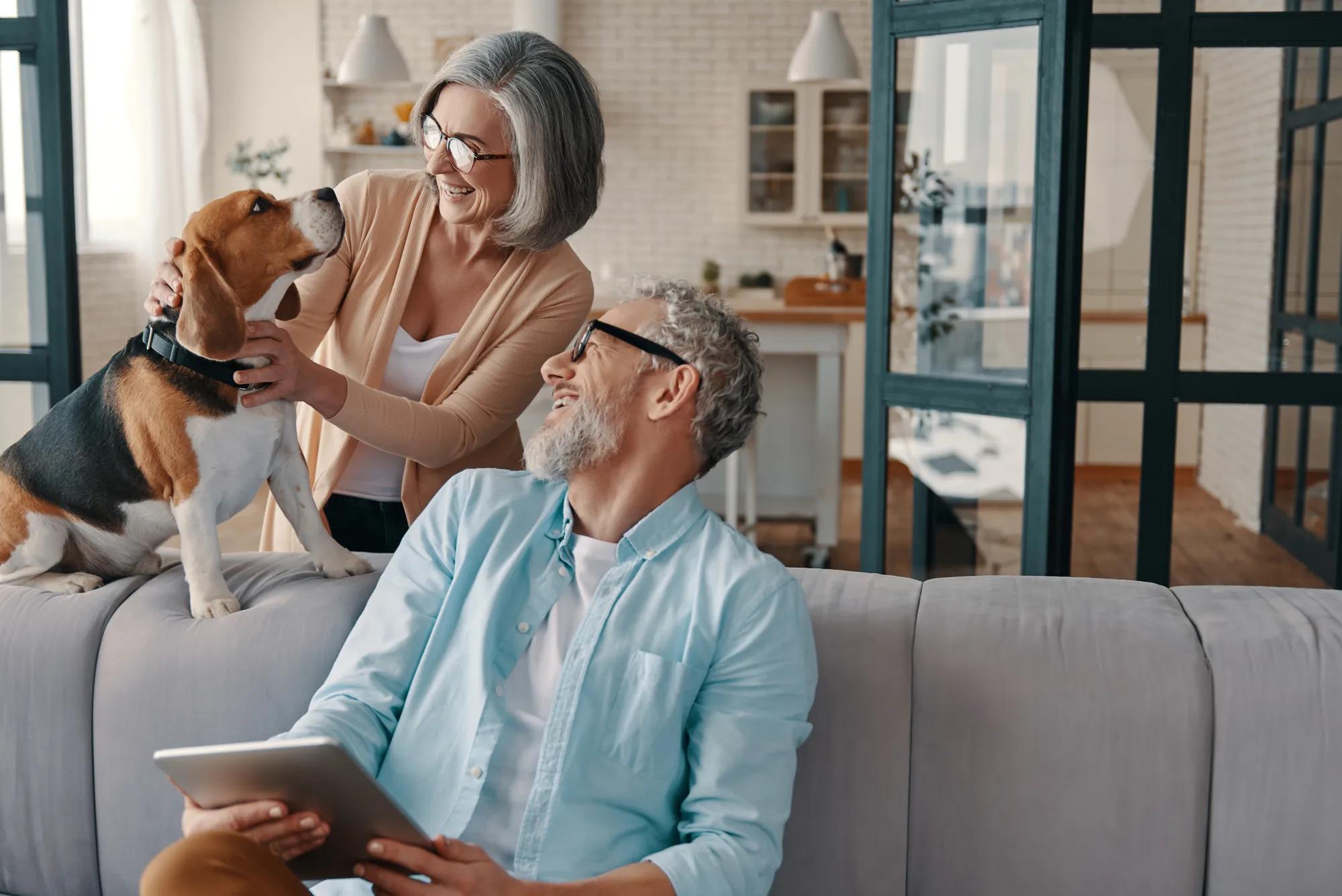 Couple with dog in new home family room