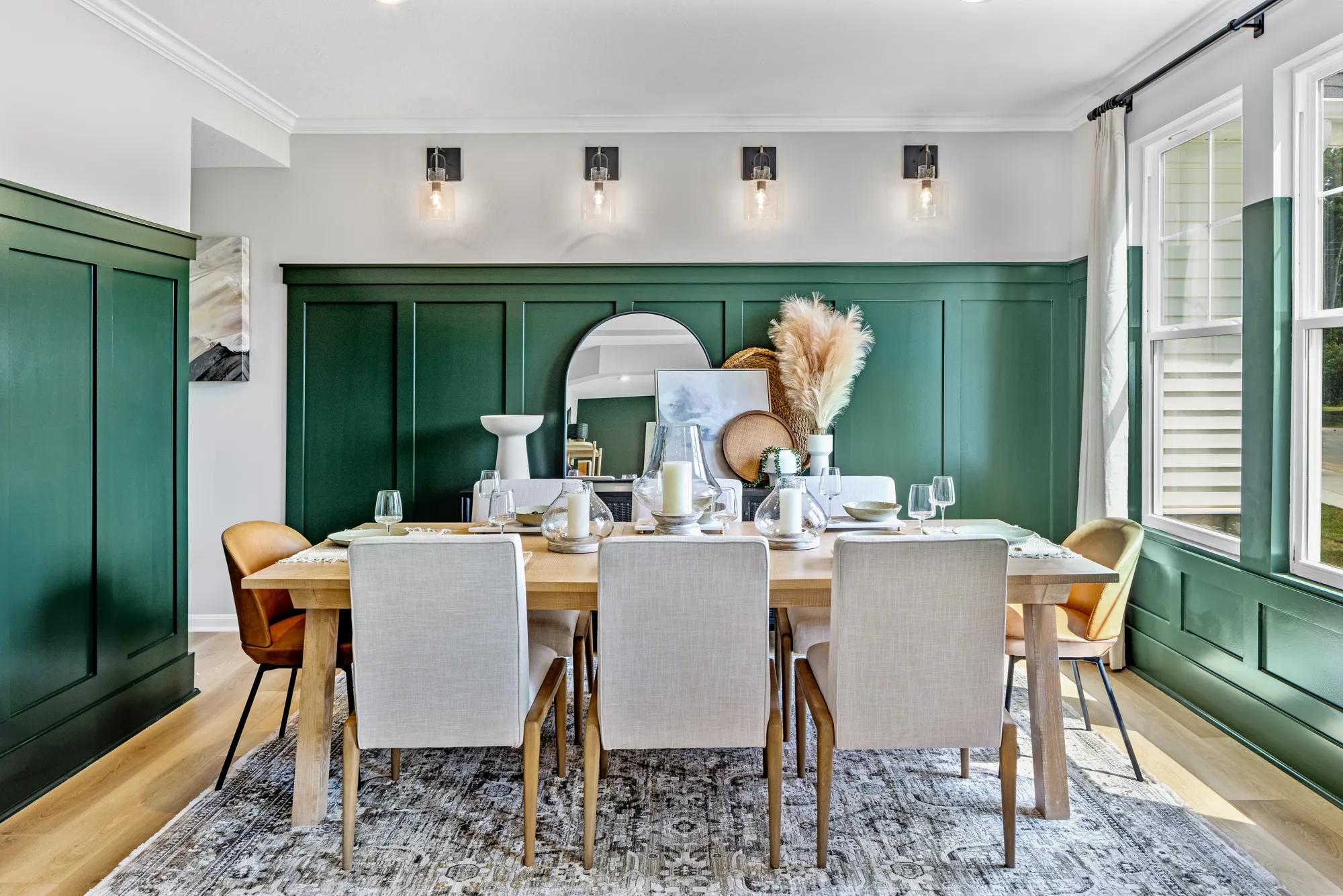 dining room with deep green wainscoting