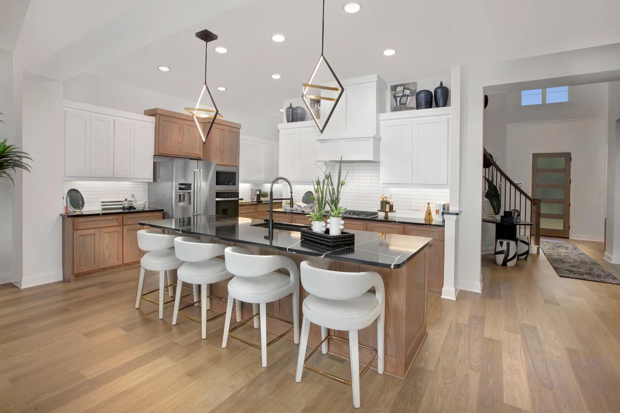 new home kitchen with light wood and white cabinets