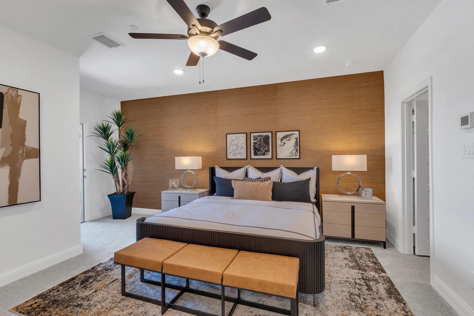 New townhome primary suite bedroom with orange wallpaper accent wall
