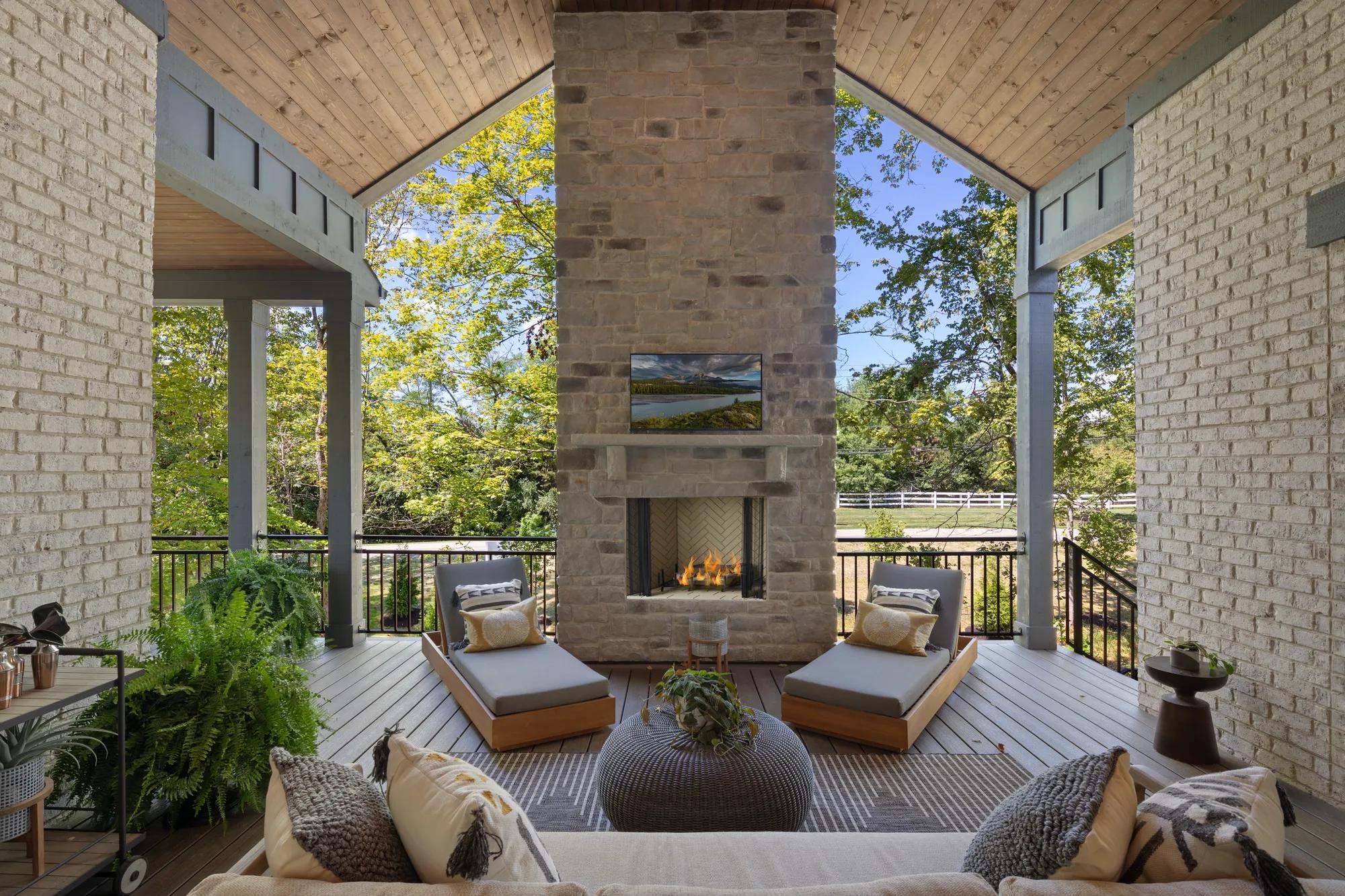 vaulted ceiling covered patio with stone fireplace