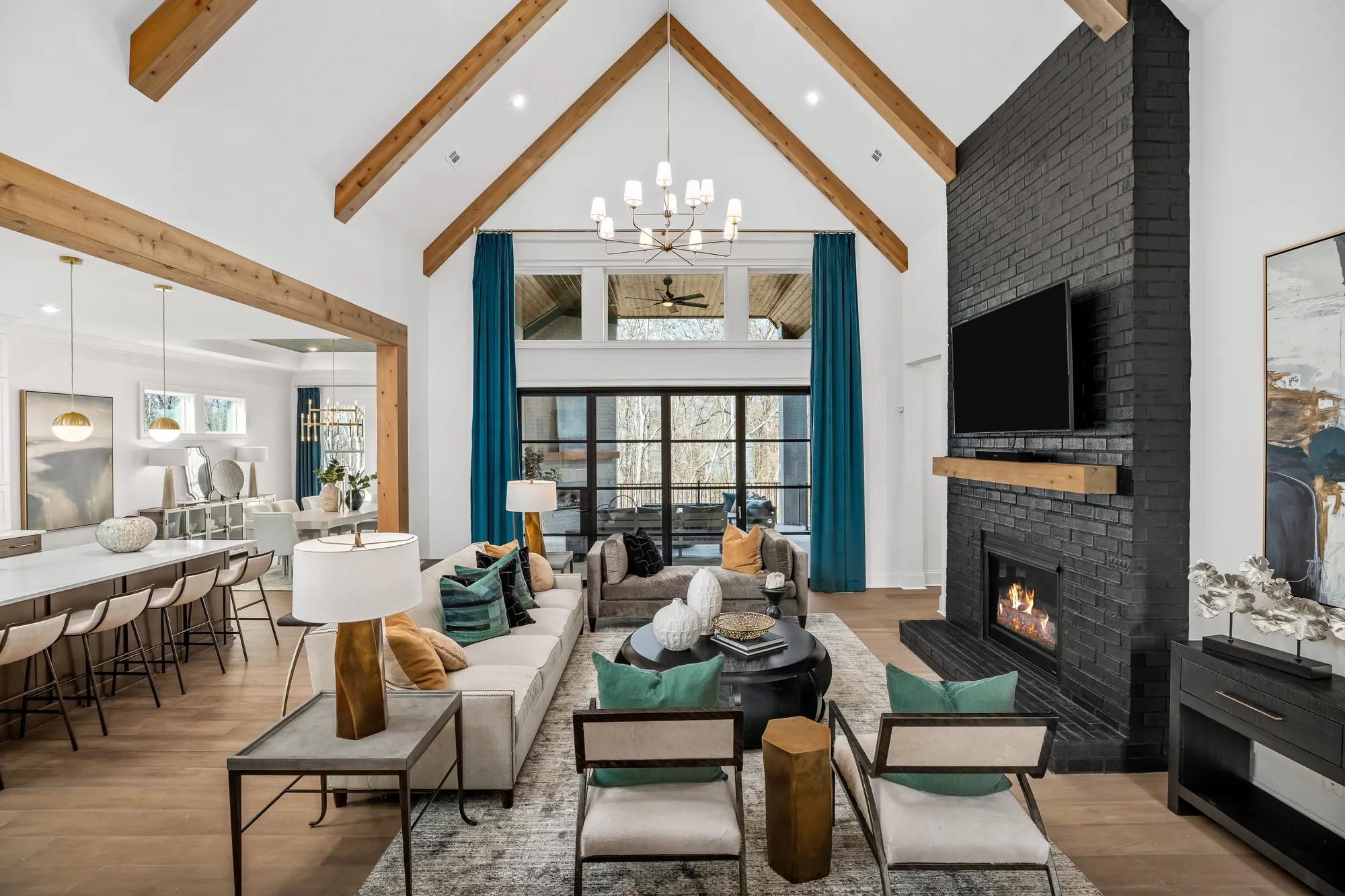 new home family room with vaulted beam ceiling