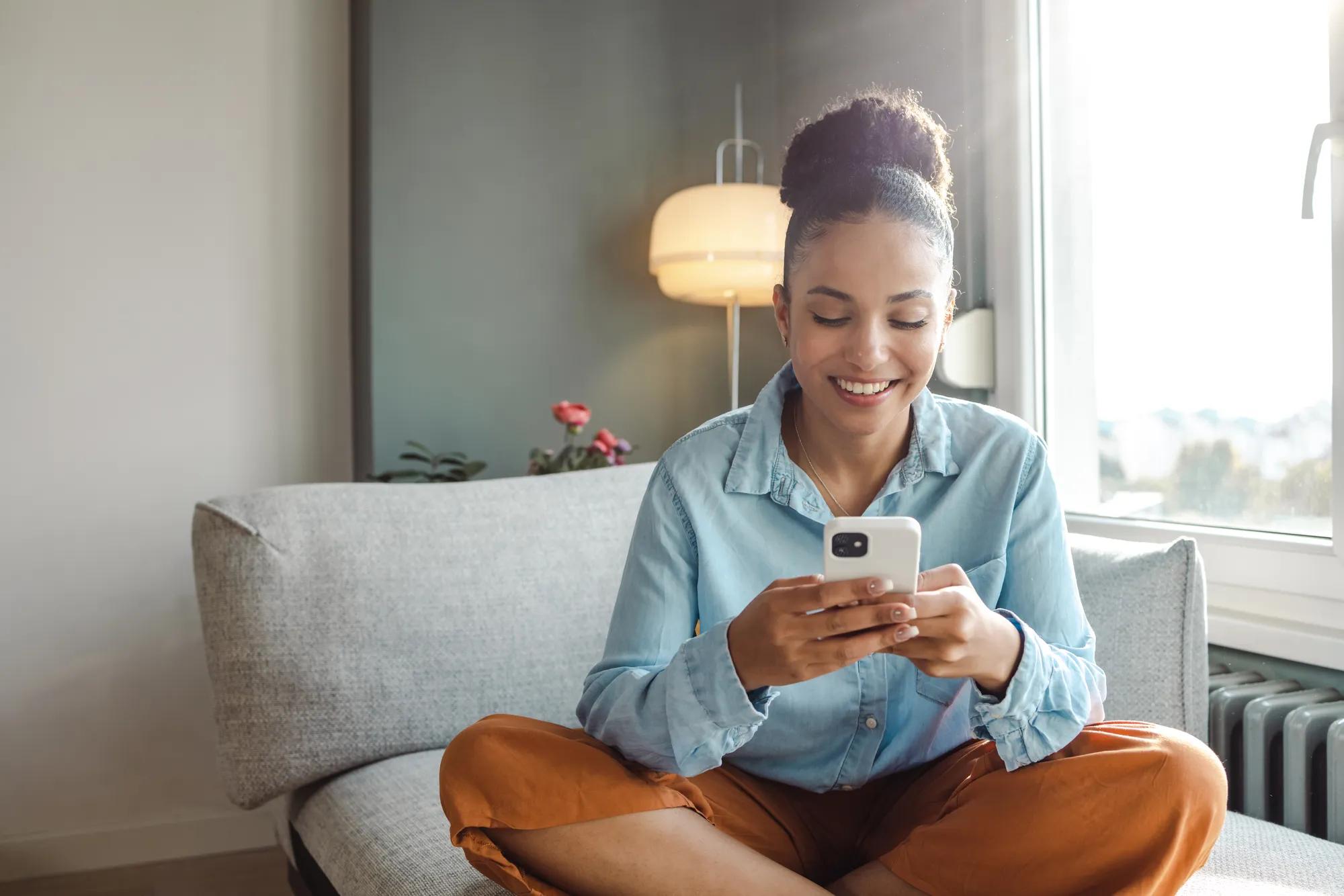 Woman using phone in family room