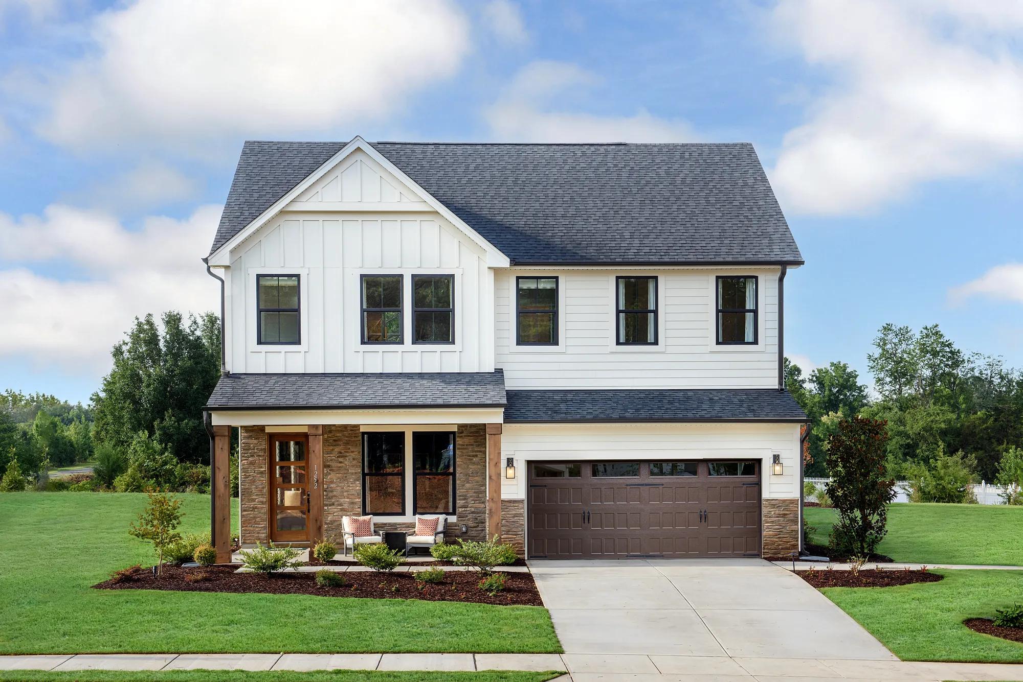 New construction exterior with front-facing garage and covered front porch