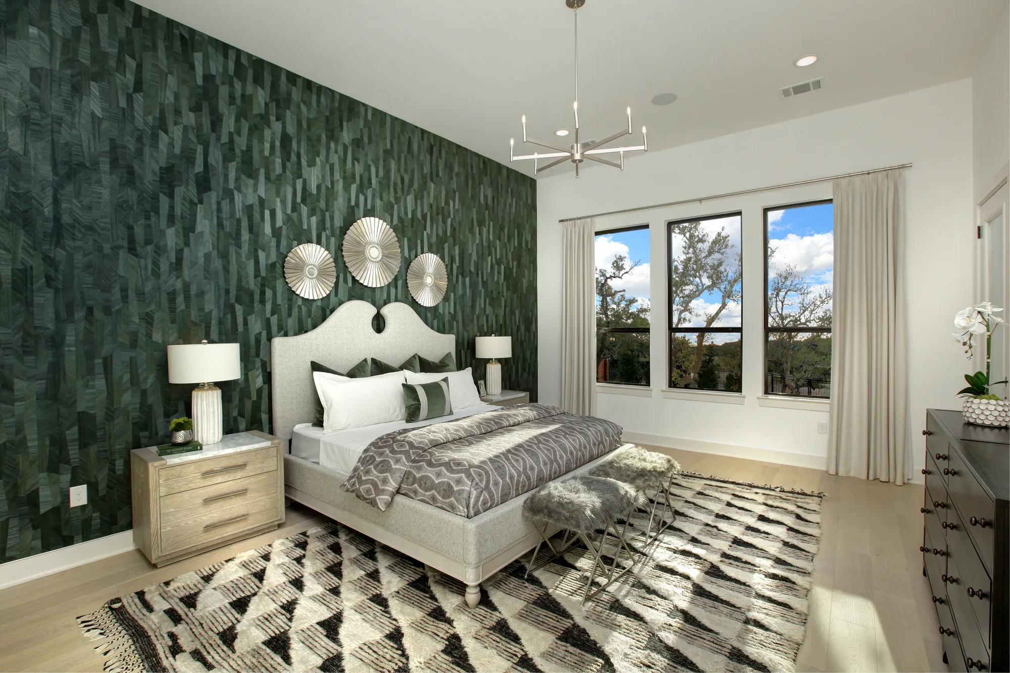 Primary Suite with chandelier and accent wall