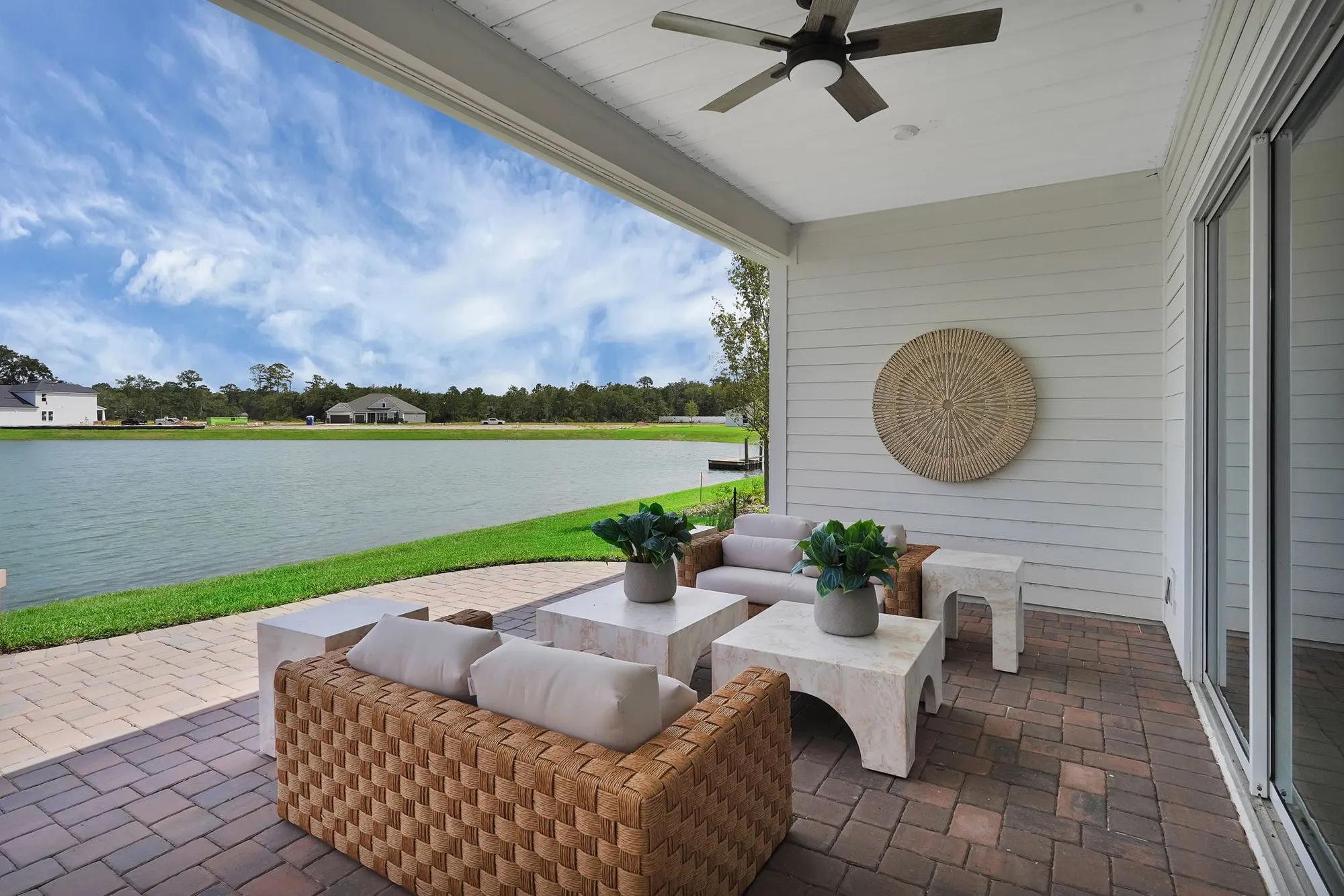 New home covered pavestone patio overlooking pond in Yulee, FL