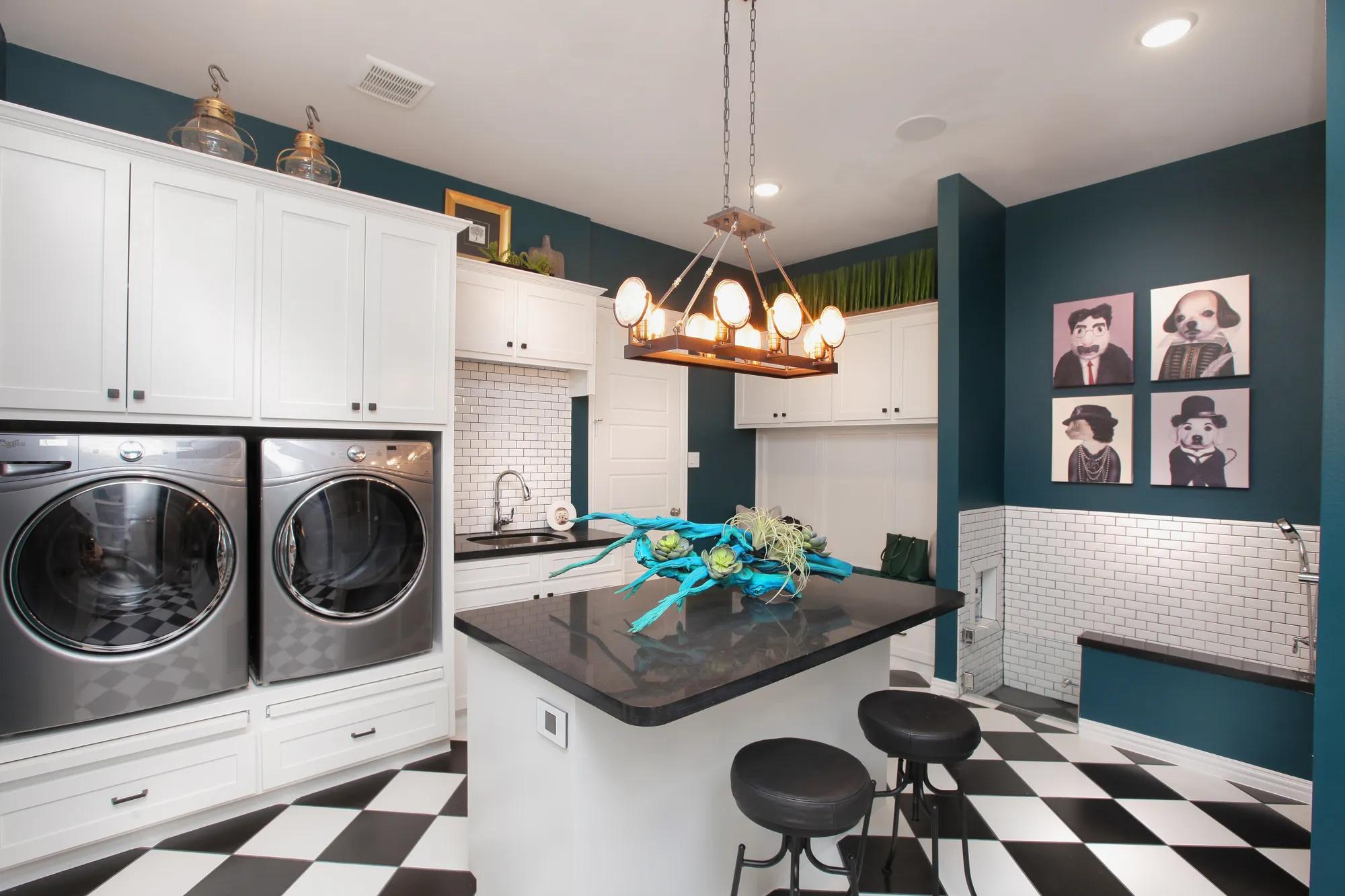 Laundry room with washer, dryer, island and dog wash