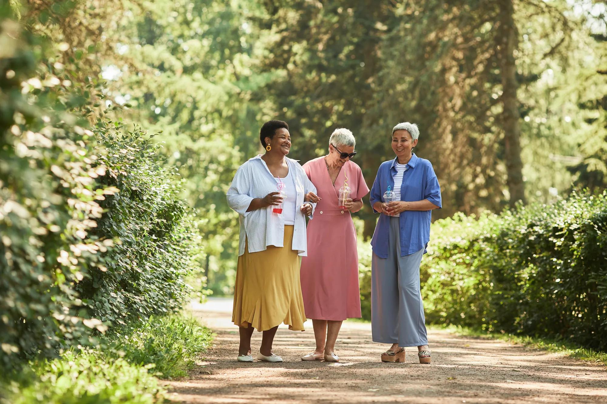 Friends walking on outdoor park trail