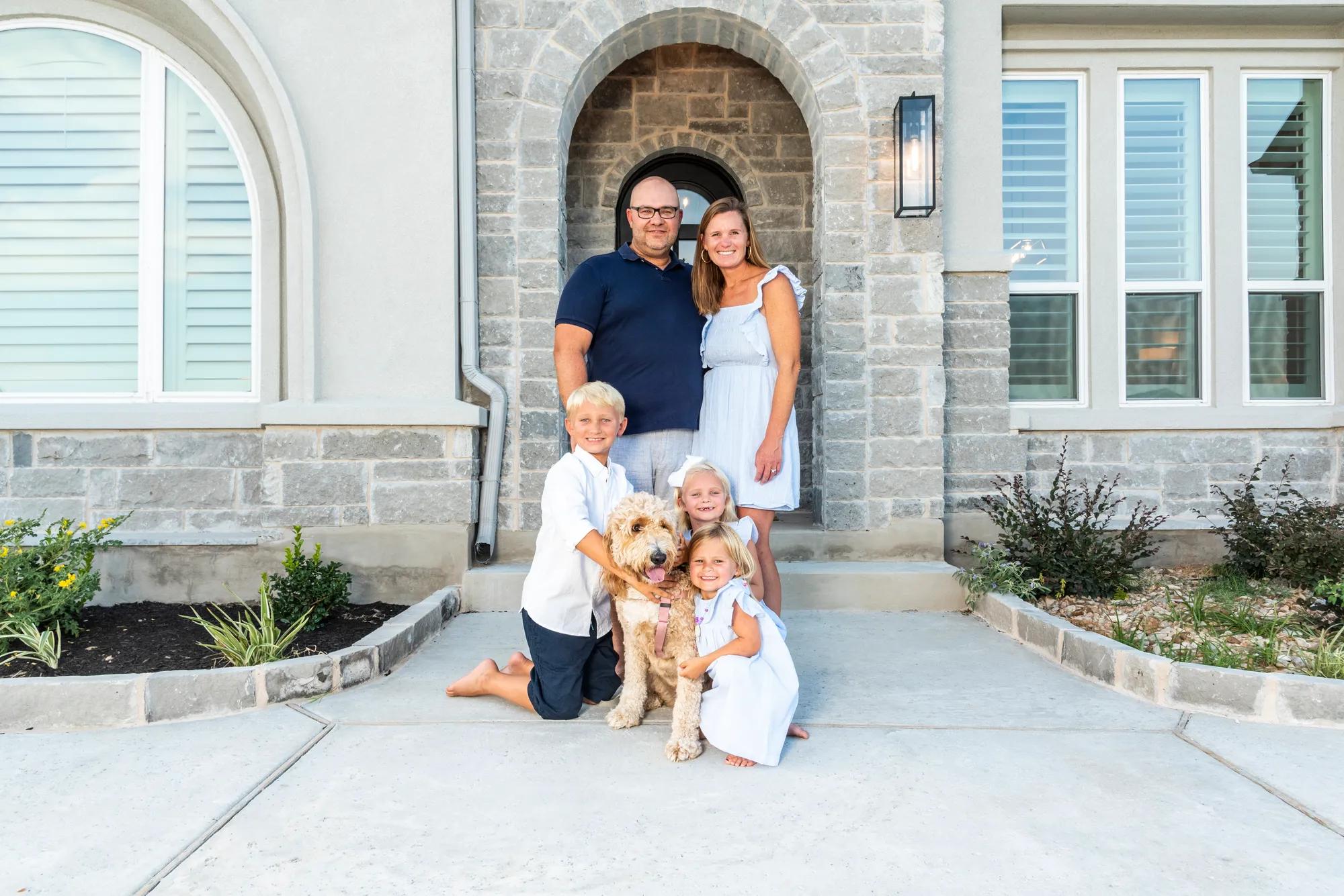 New homeowners outside of their Drees Home exterior