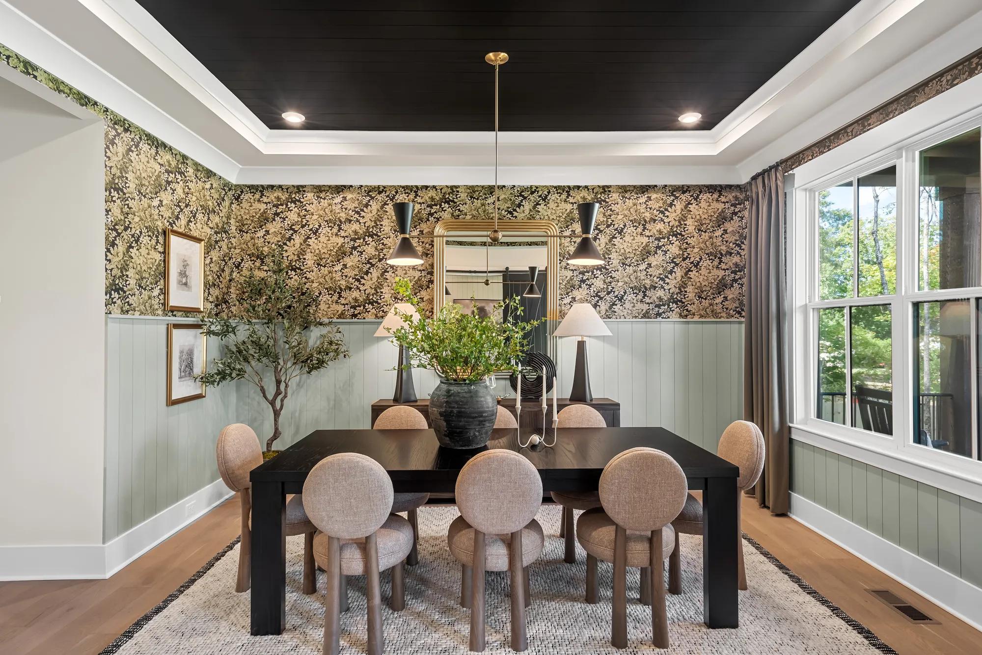 Custom home dining room with black painted ceiling, green shiplap and wallpaper