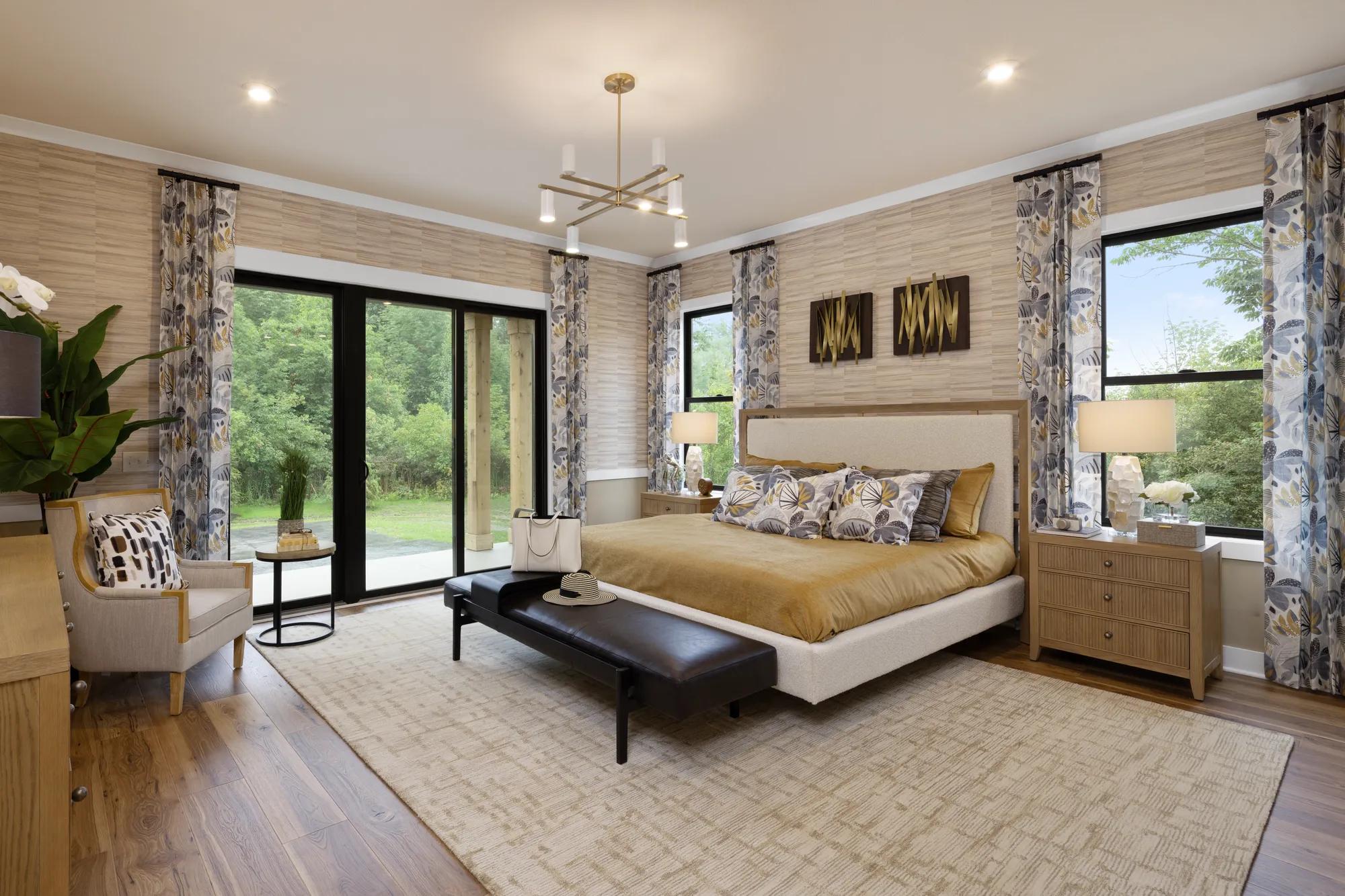 Custom home primary suite bedroom with sliding glass door walkout