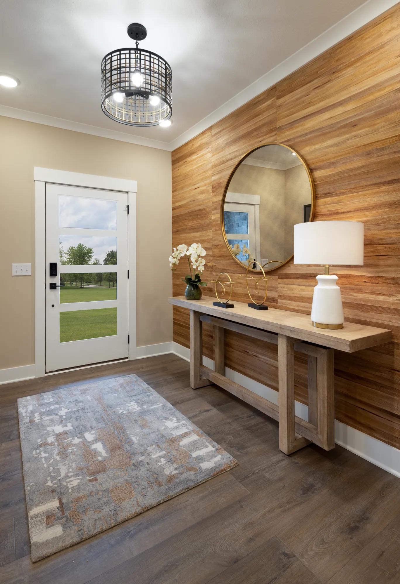 foyer with side table and round mirror