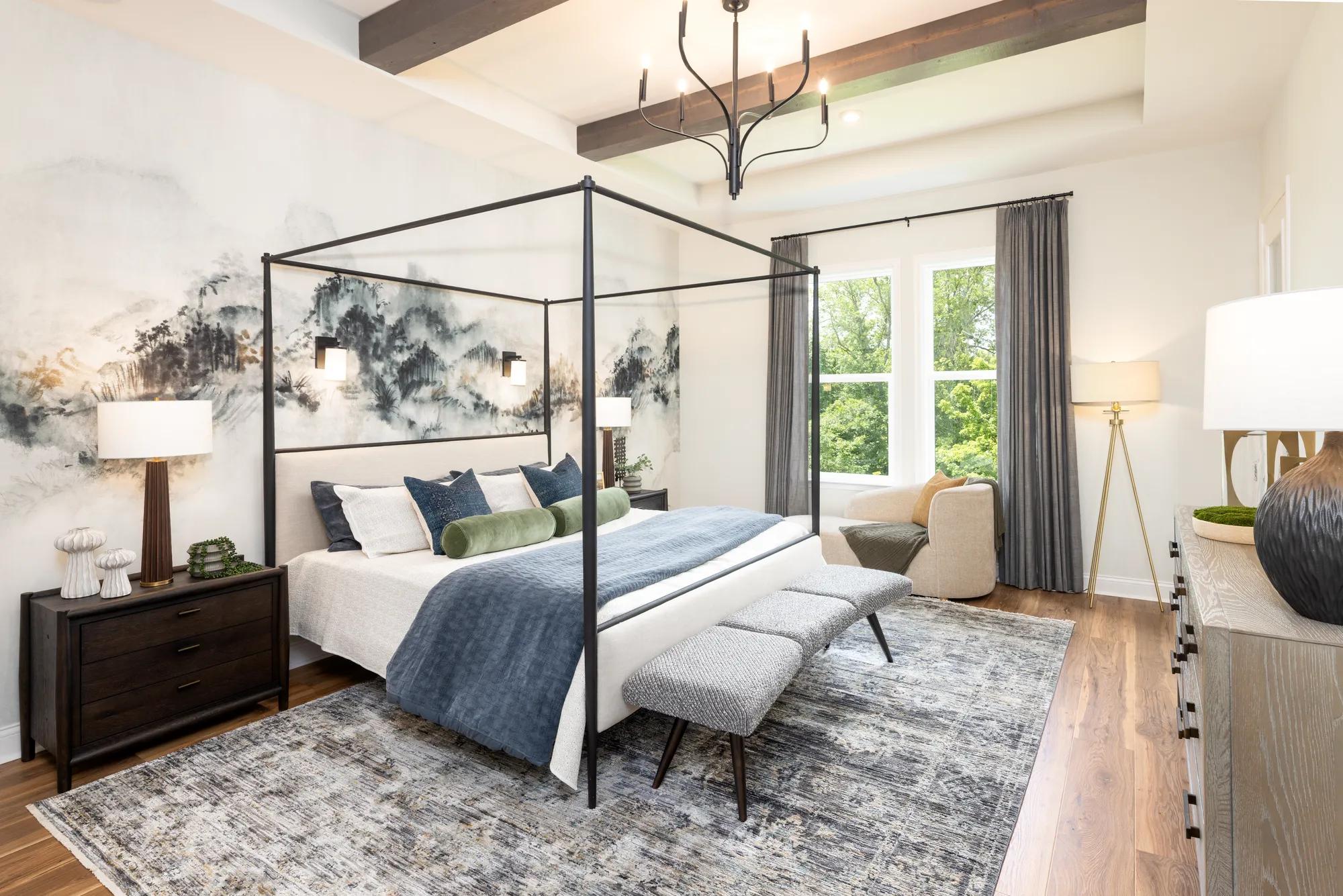 Modern home primary bedroom with wood beam ceiling, chandelier, and hardwood floor