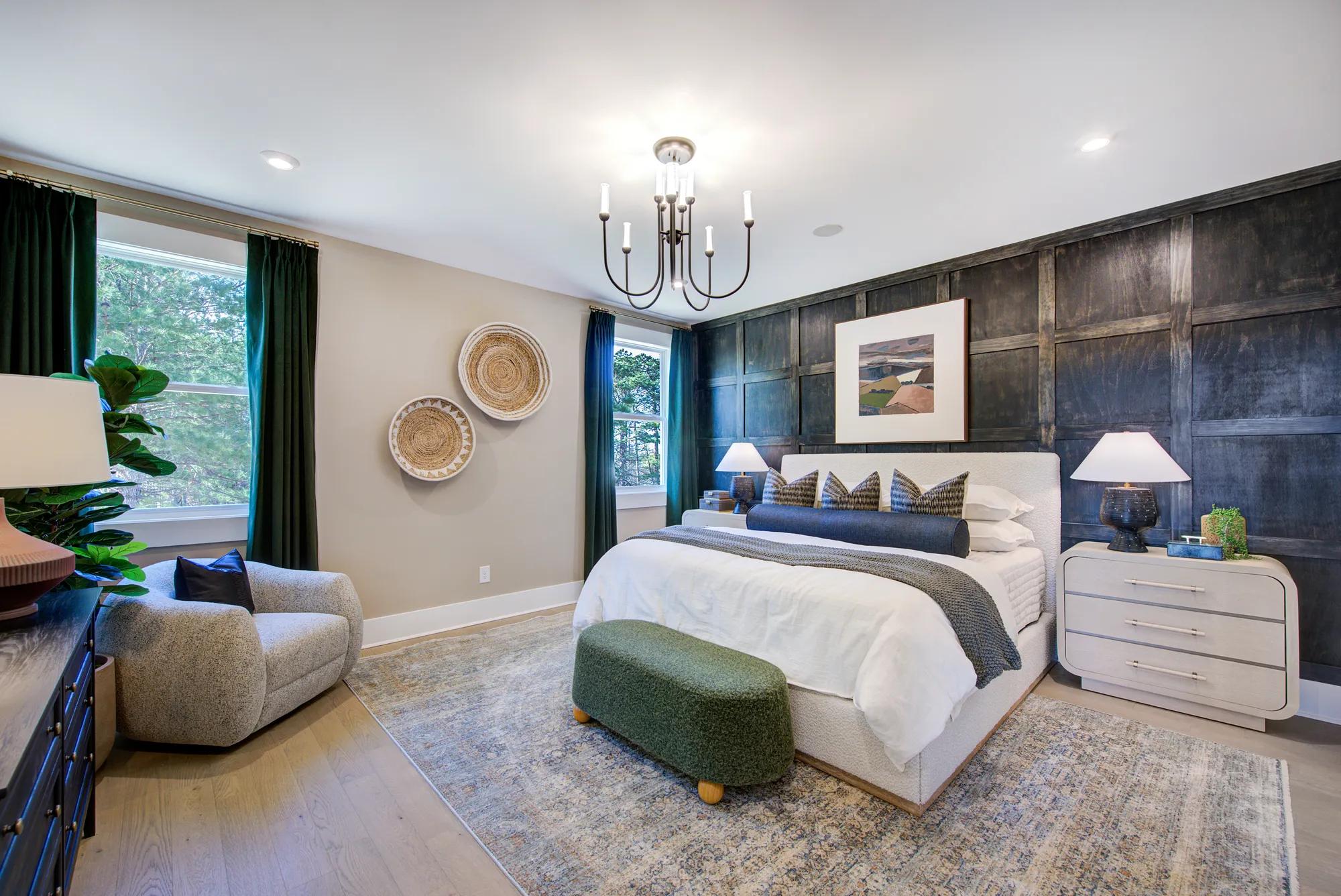 Custom home primary bedroom with wood accent wall and hardwood floor